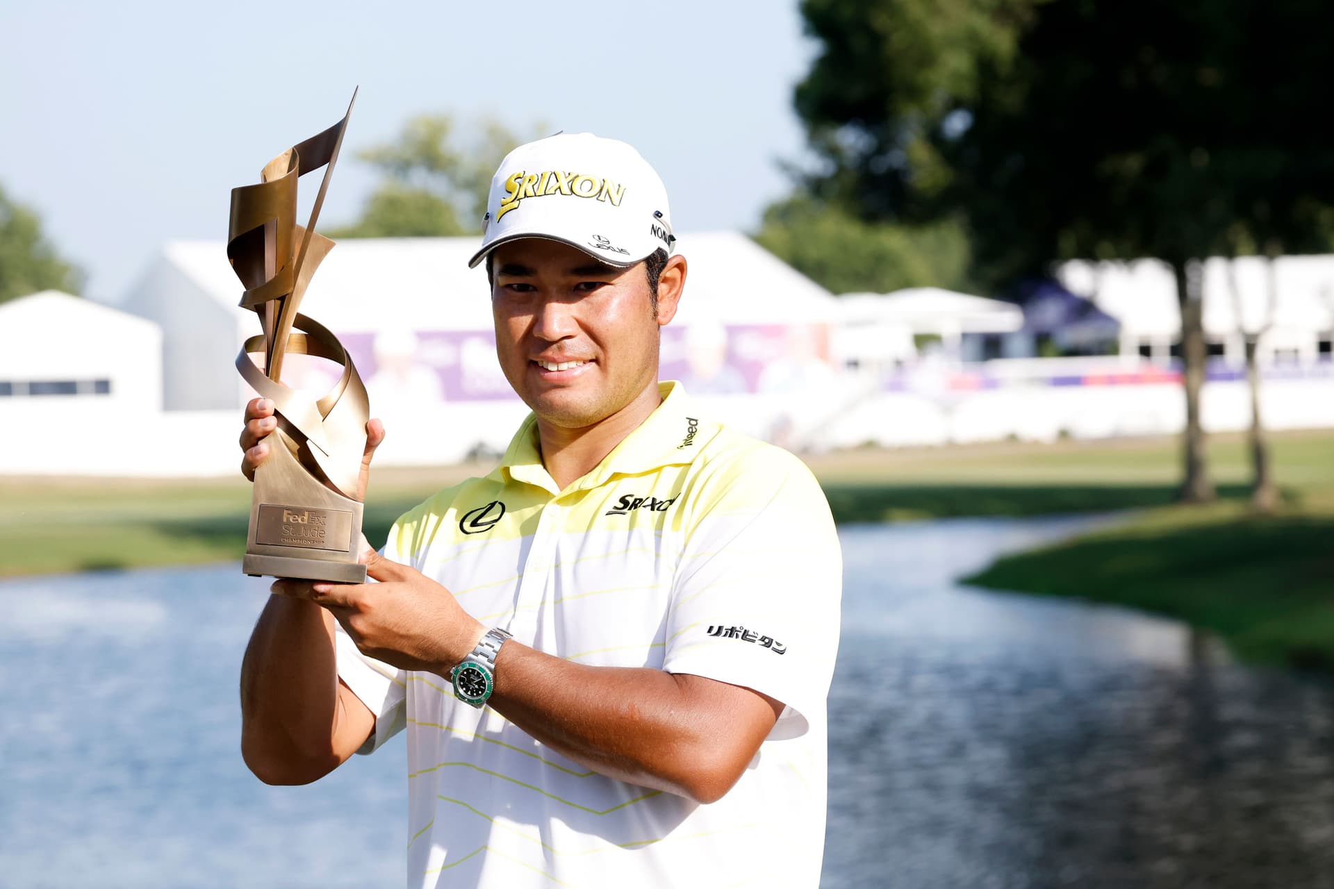 Hideki Matsuyama holds the champion's trophy