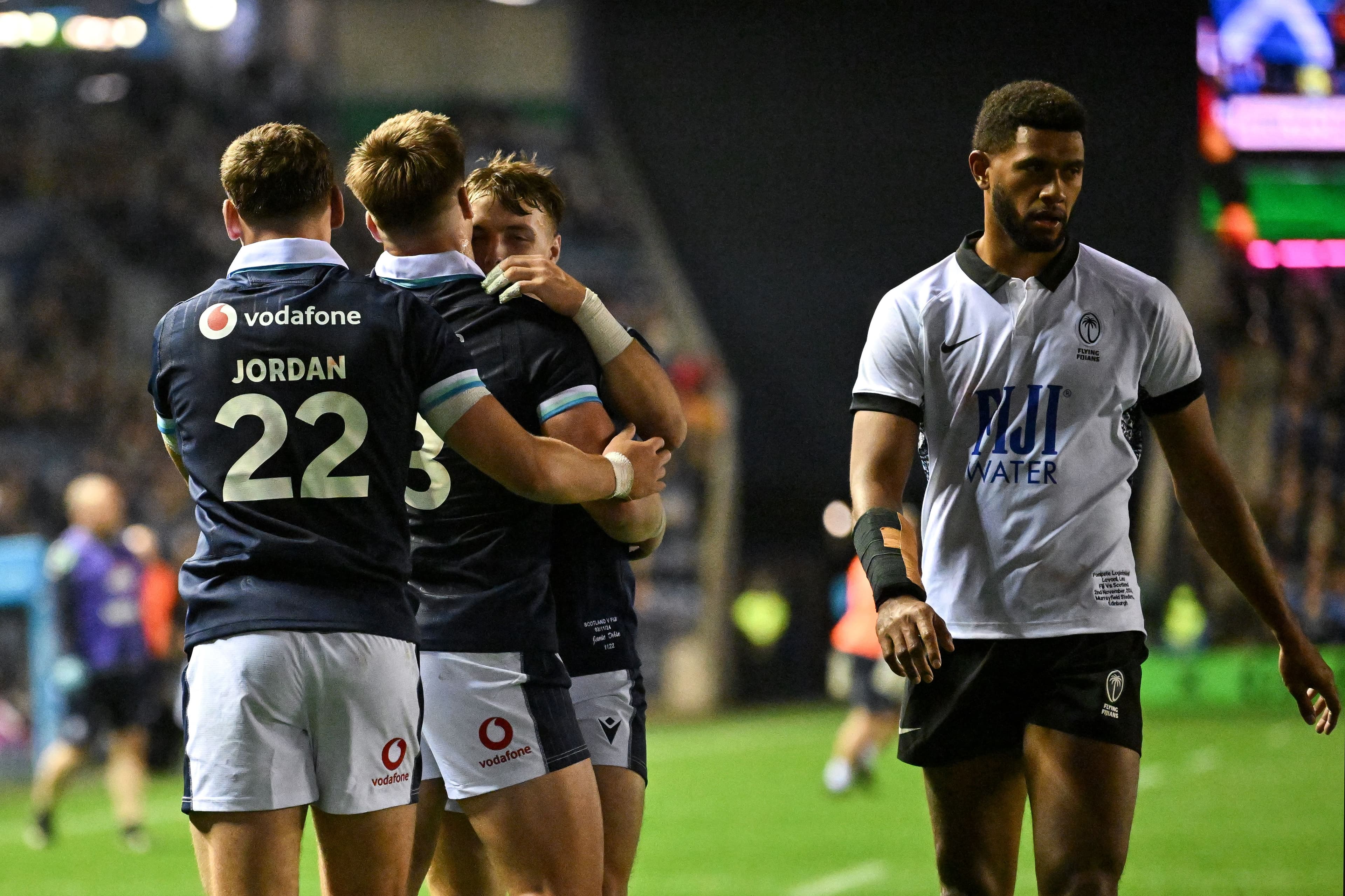 Huw Jones (2L) celebrates after scoring the team's eighth try