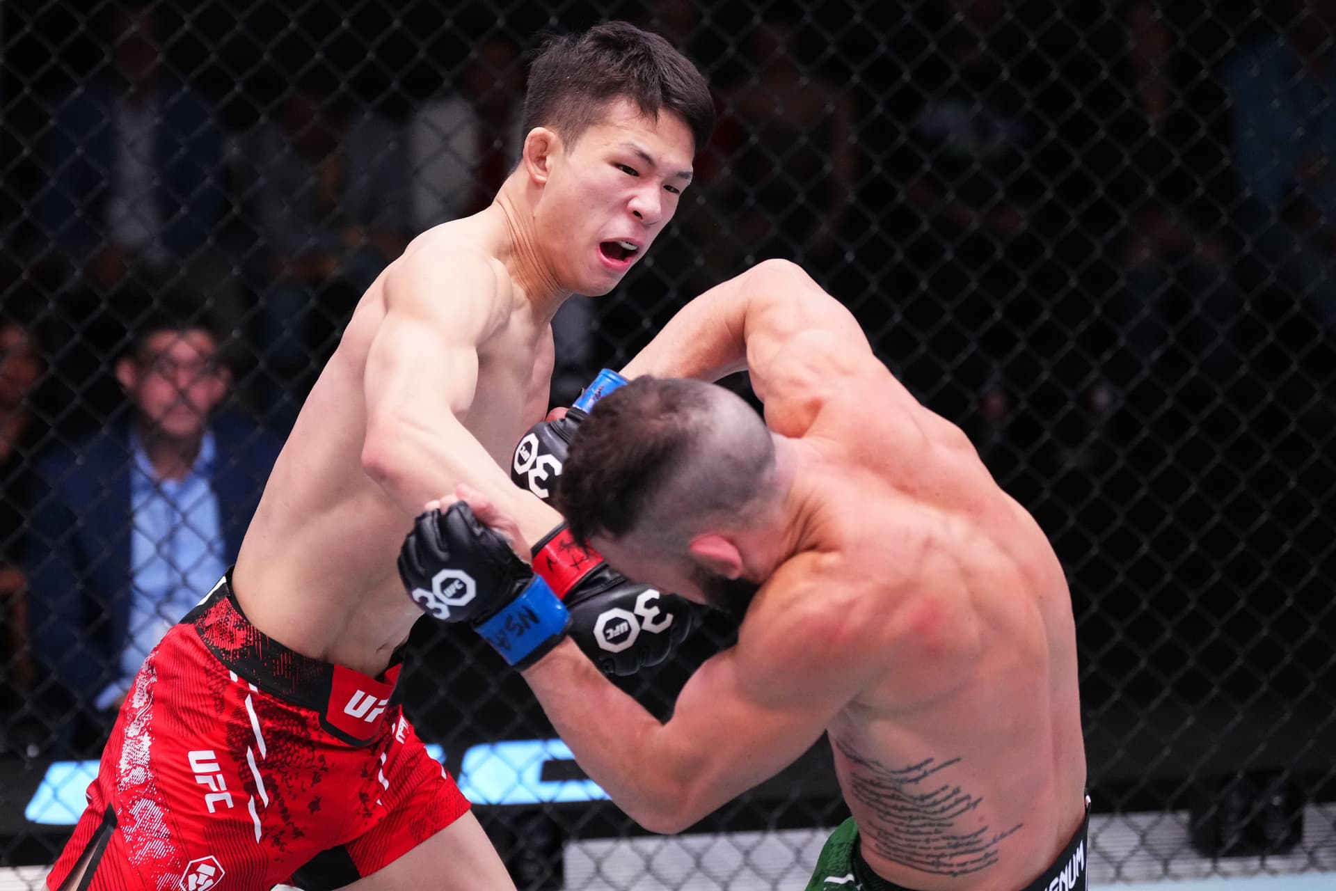 HyunSung Park of South Korea punches Shannon Ross of Australia