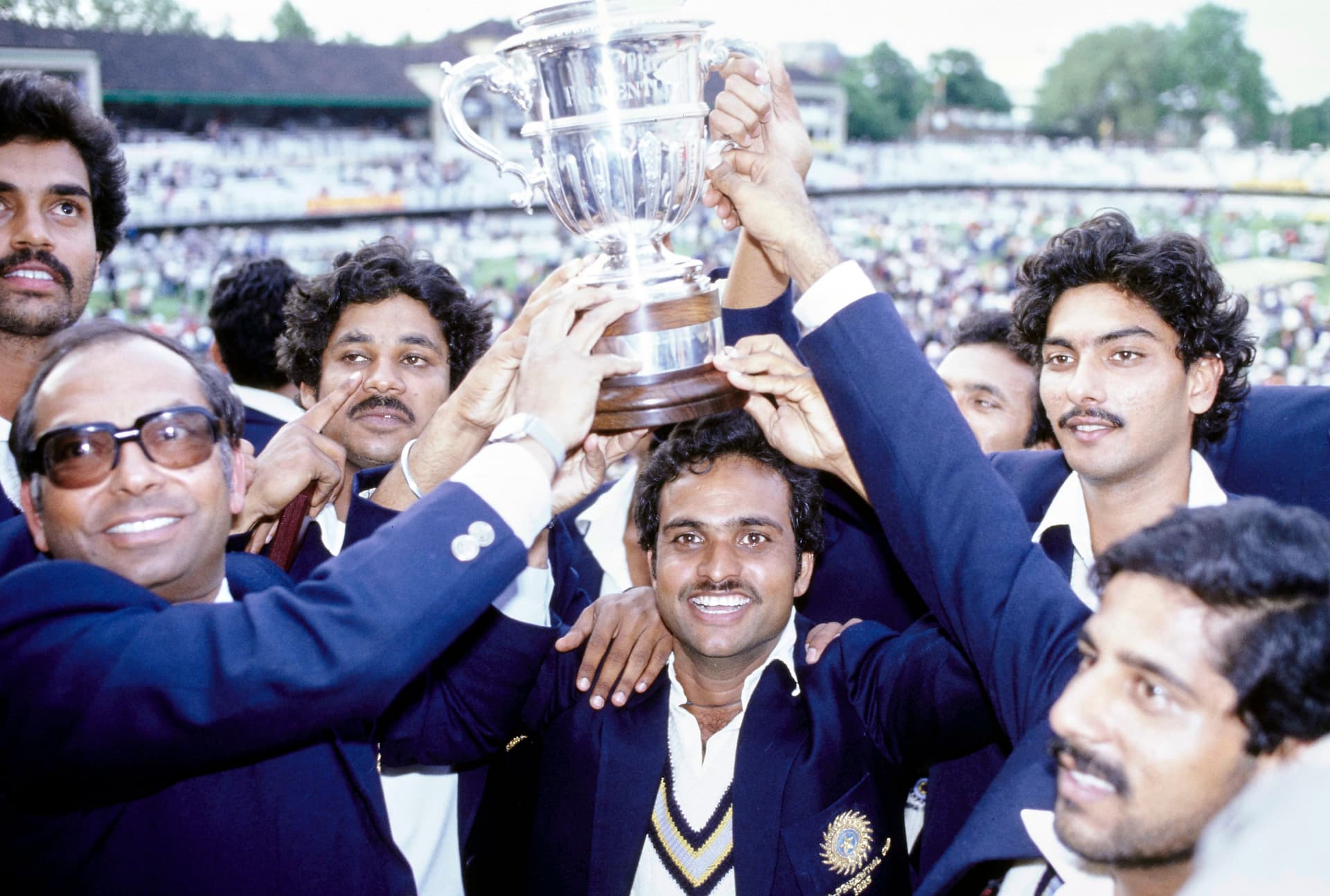 India batsman Yashpal Sharma holds the trophy with squad players