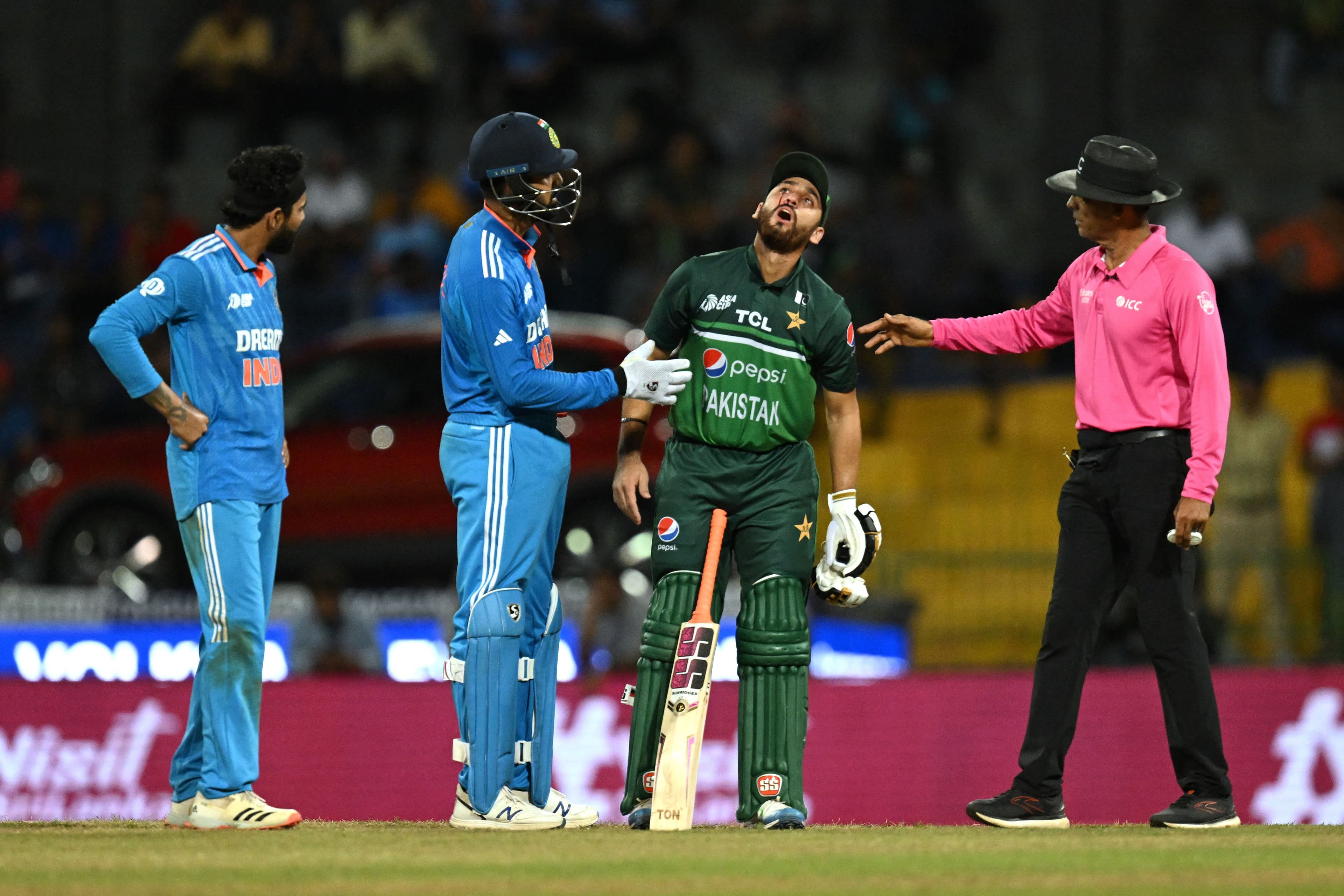 India's wicketkeeper Ishan Kishan comforts Pakistan's Agha Salman