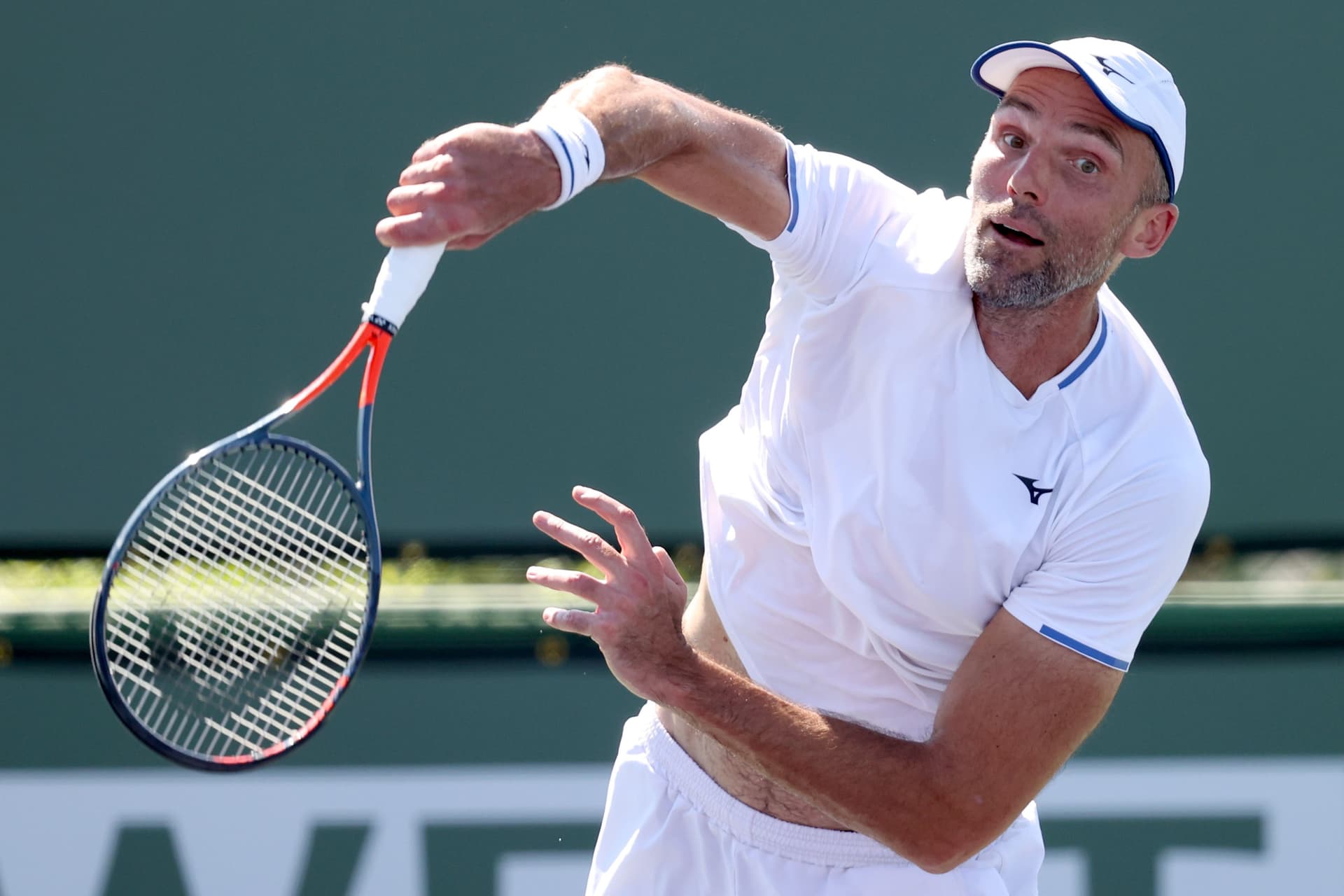 Ivo Karlovic of Croatia serves to Brayden Schnur of Canada