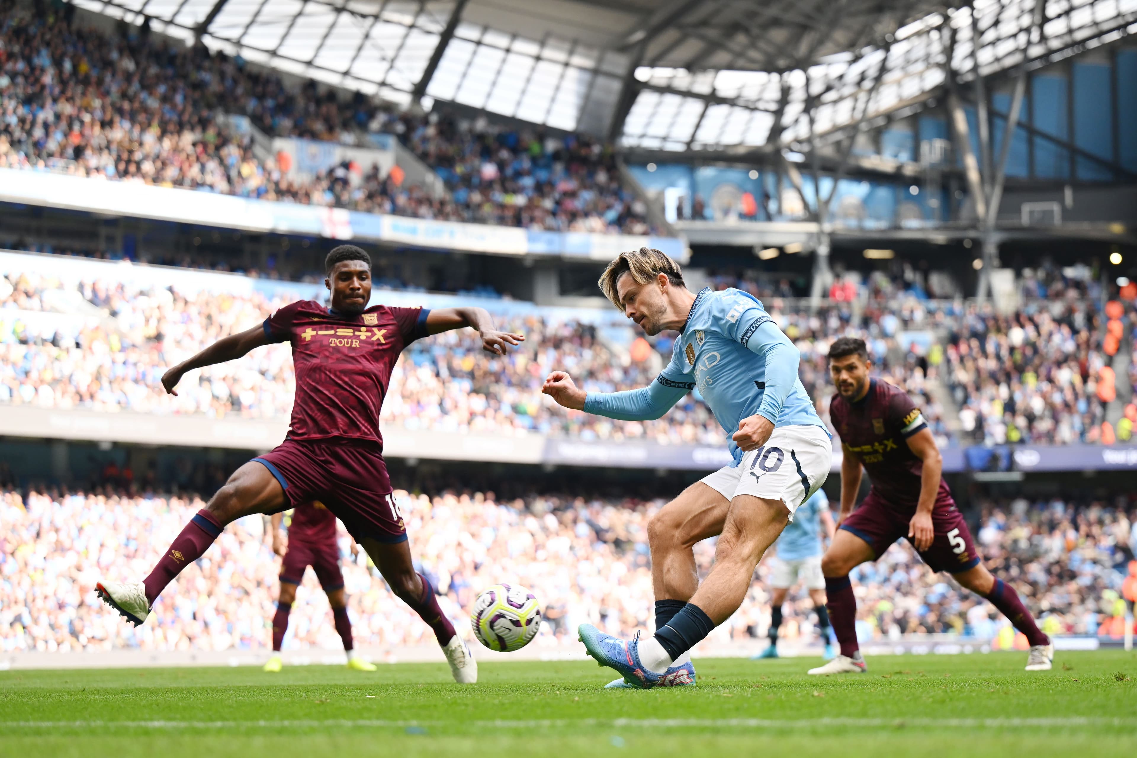 Jack Grealish in action with Ben Johnson