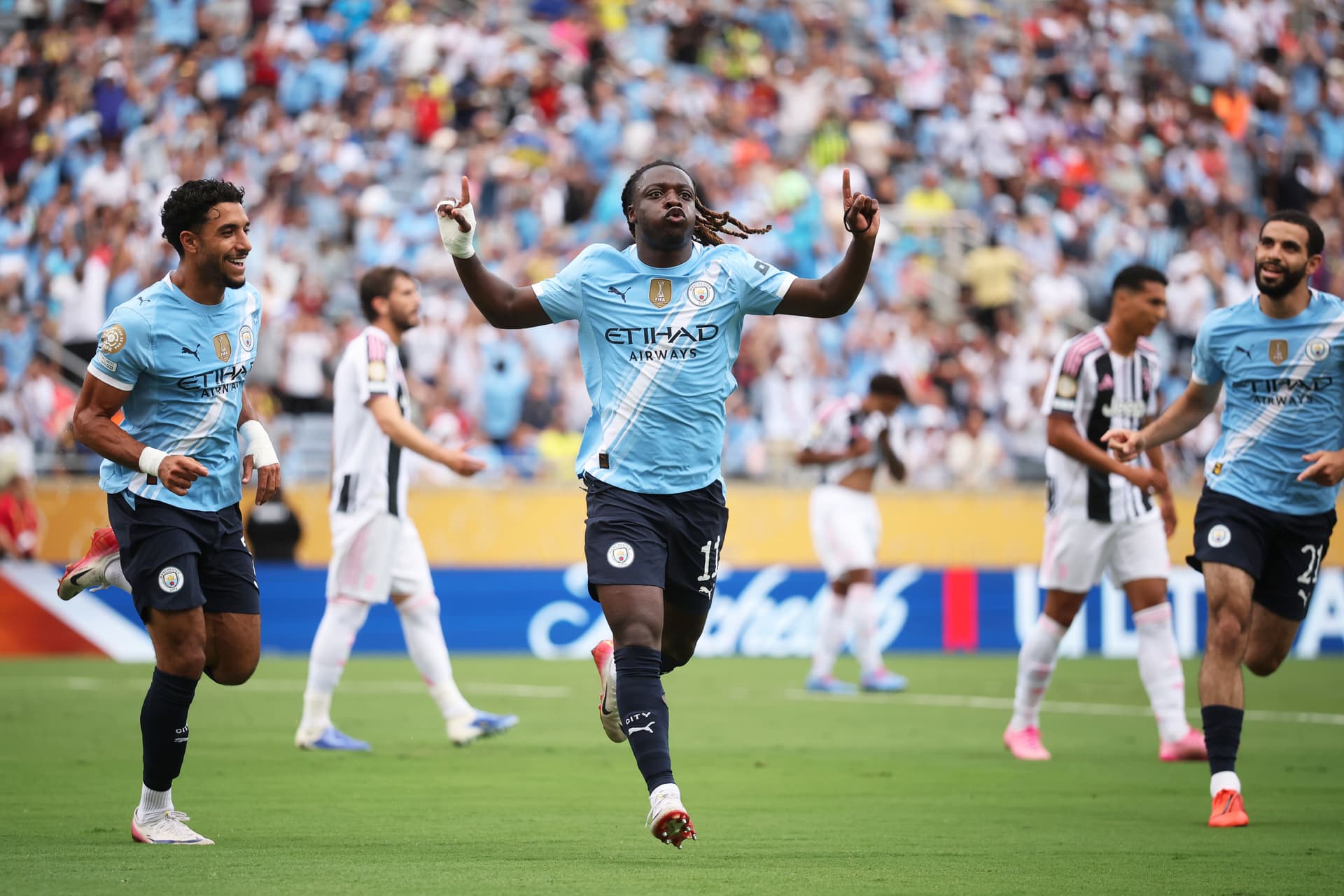 Jeremy Doku #11 of Manchester City celebrates scoring his team's first goal