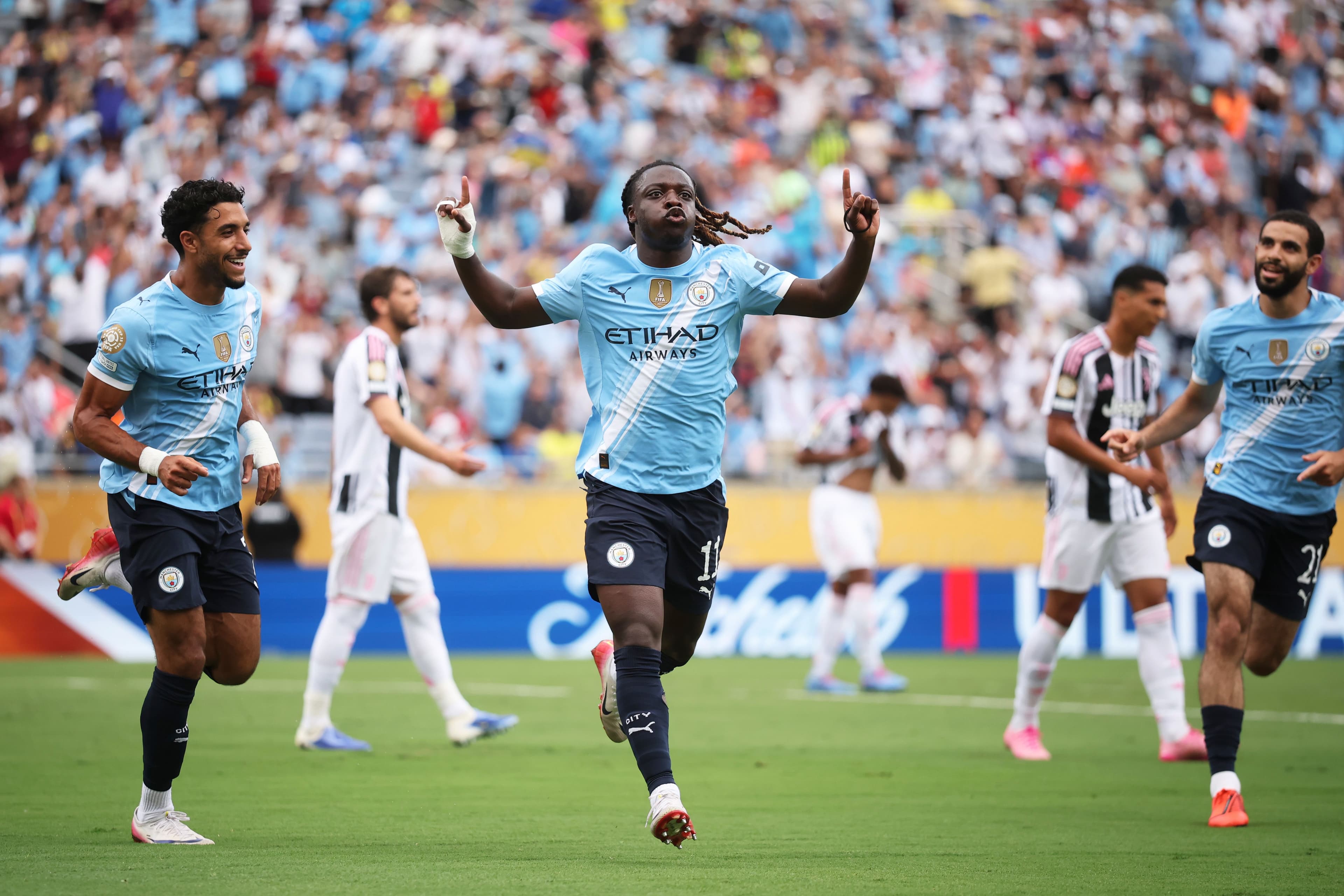 Jeremy Doku #11 of Manchester City celebrates scoring his team's first goal