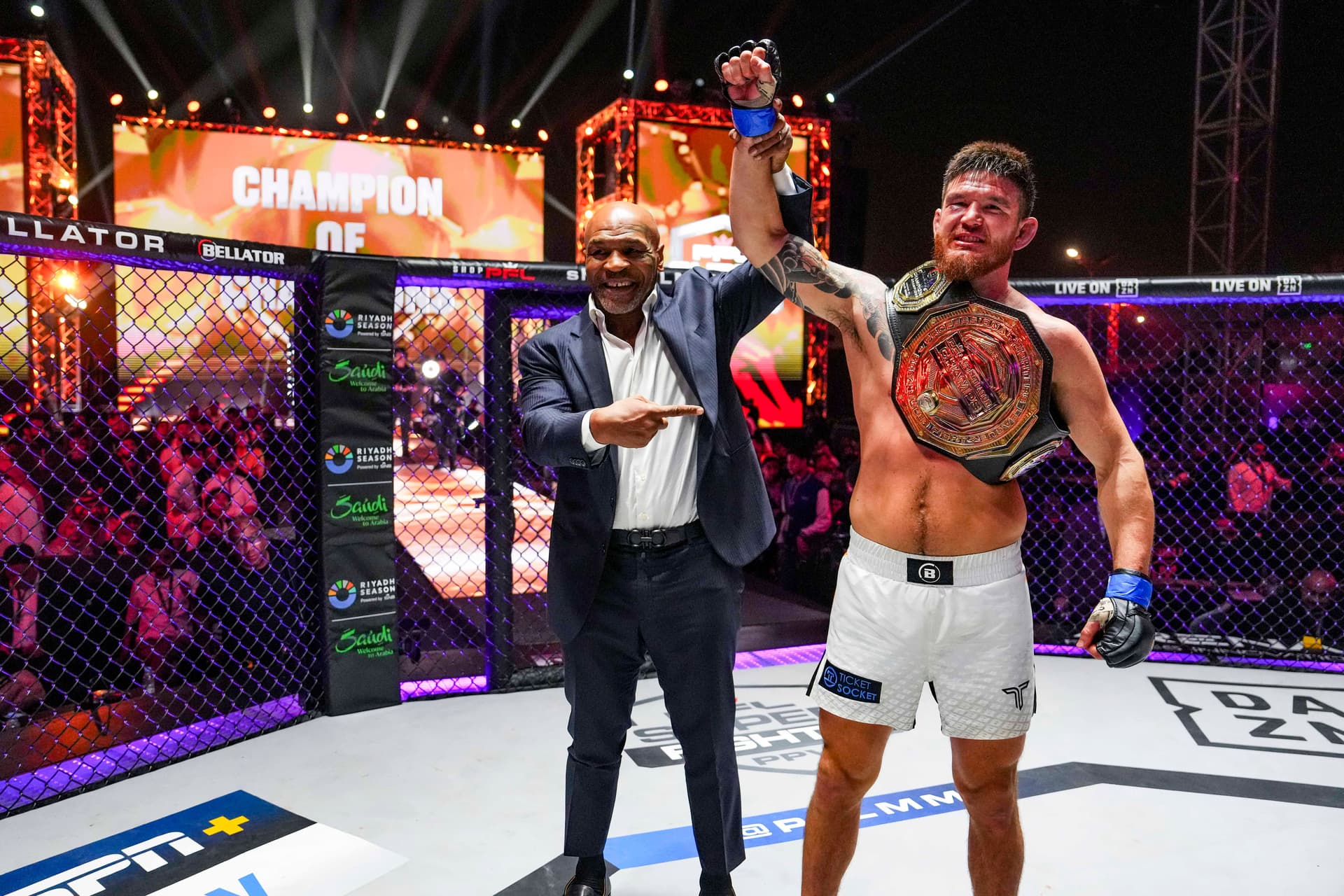 Johnny Eblen celebrates with Mike Tyson after defeating Impa Kasangana