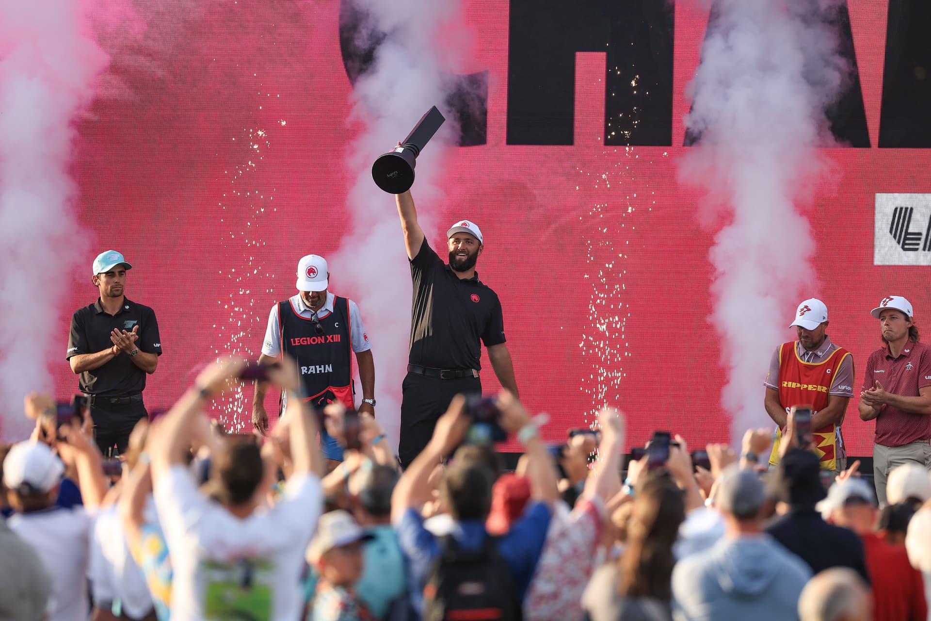 Jon Rahm of Spain raises the individual winner's trophy