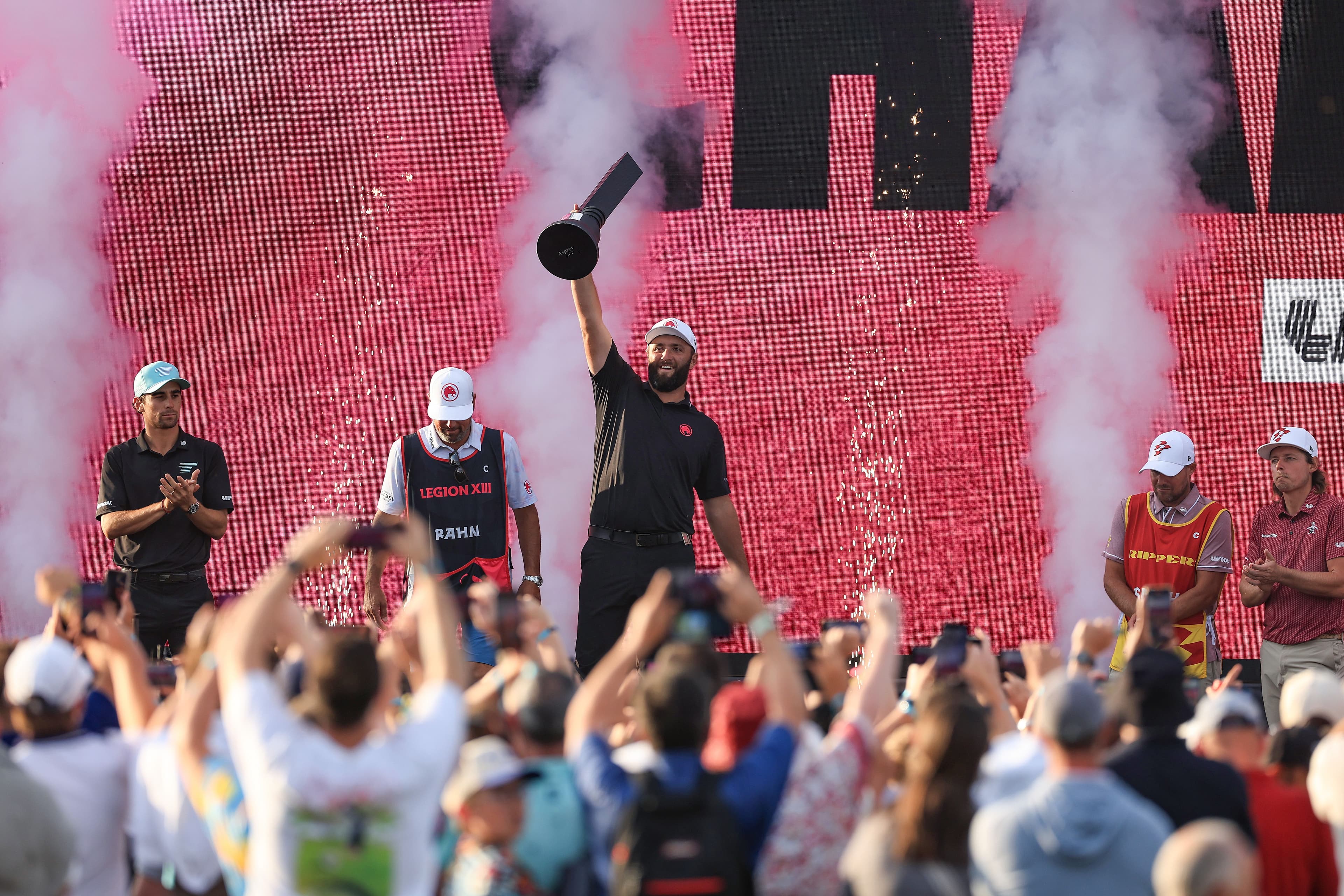 Jon Rahm of Spain raises the individual winner's trophy