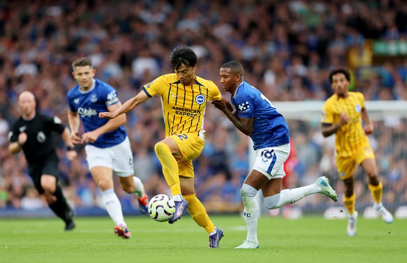 Kaoru Mitoma of Brighton & Hove Albion is fouled by Ashley Young of Everton