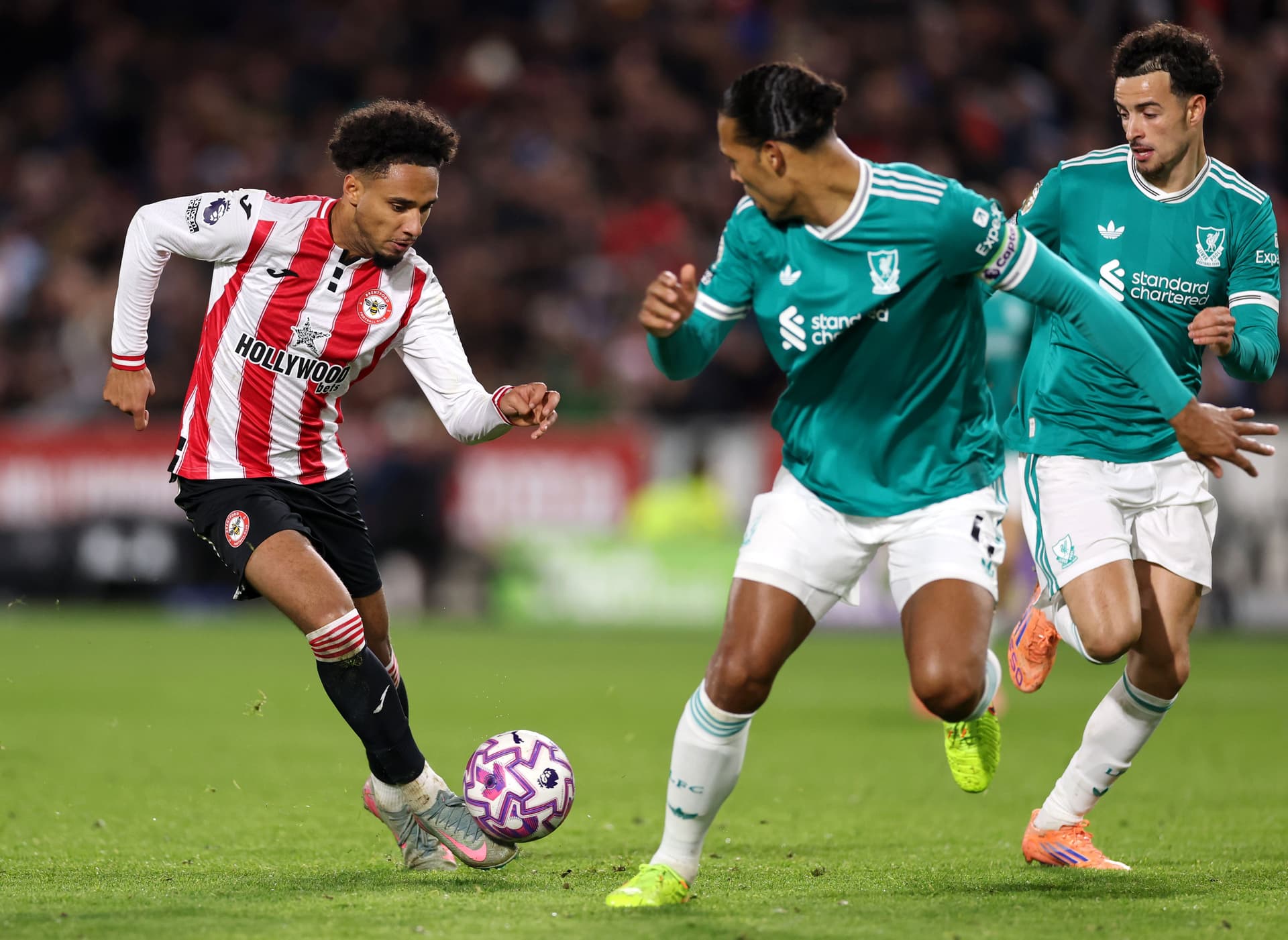 Kevin Schade of Brentford gets past Curtis Jones and Virgil van Dijk of Liverpool