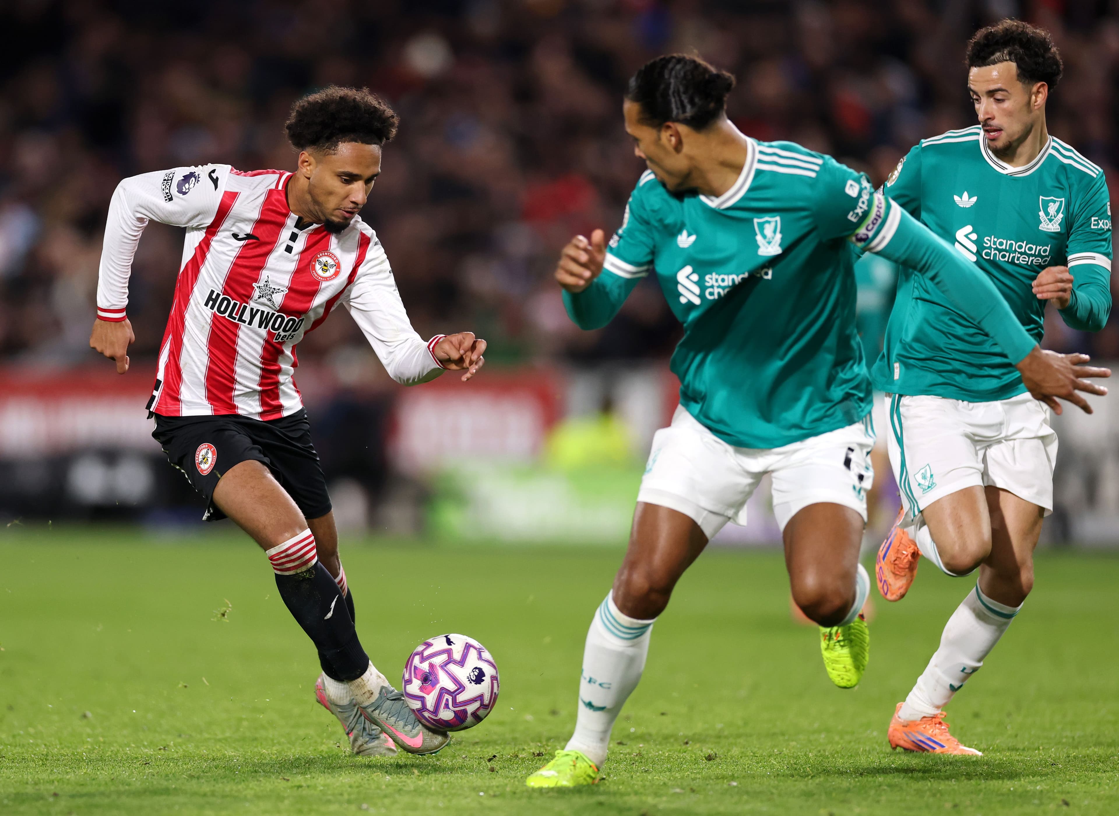 Kevin Schade of Brentford gets past Curtis Jones and Virgil van Dijk of Liverpool
