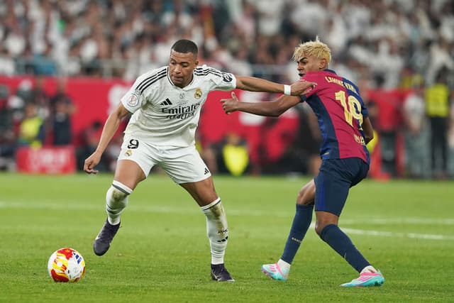Kylian Mbappe of Real Madrid CF and Lamine Yamal of FC Barcelona battle
