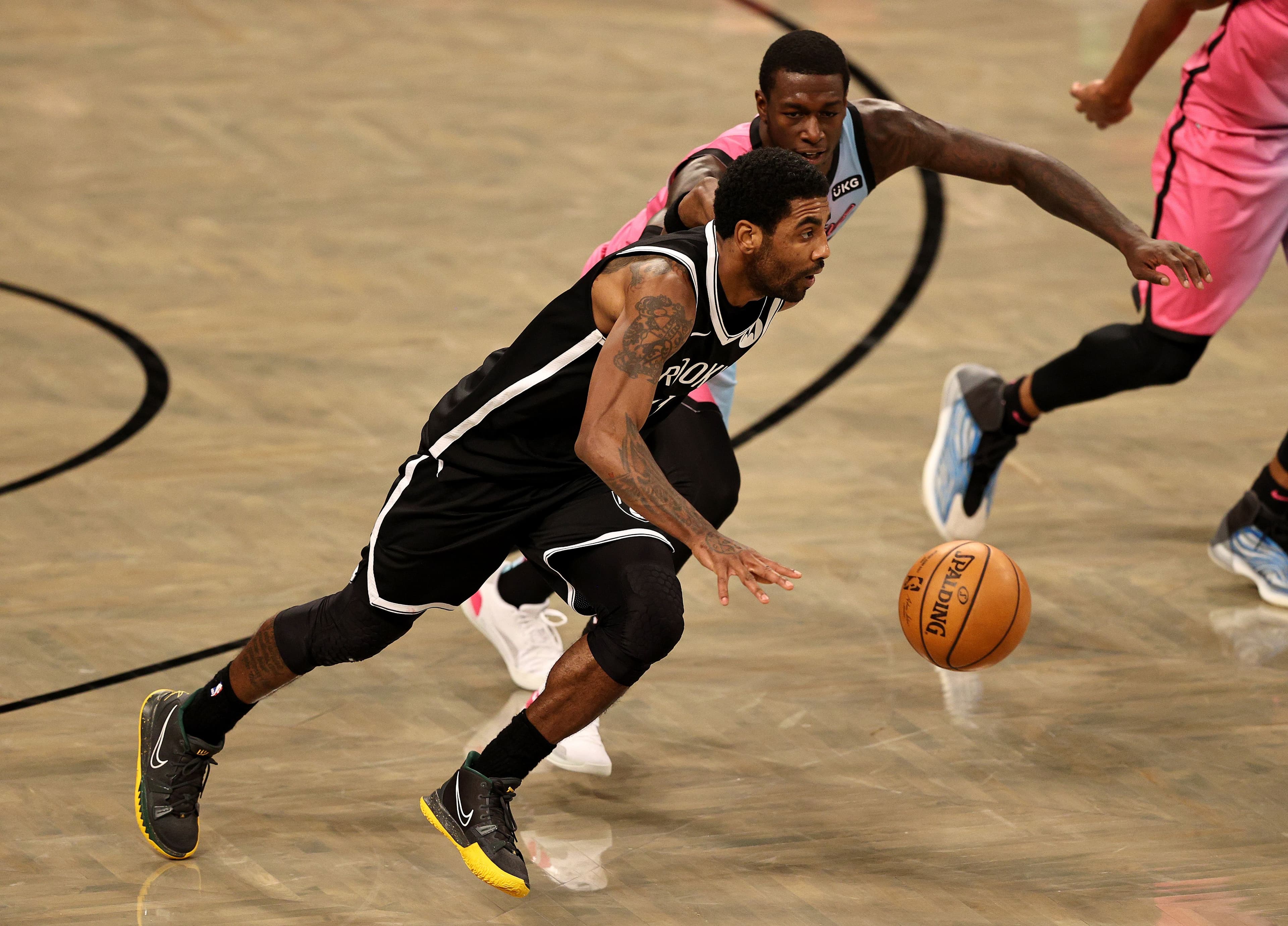 Kyrie Irving of the Brooklyn Nets heads for the net as Kendrick Nunn of the Miami Heat