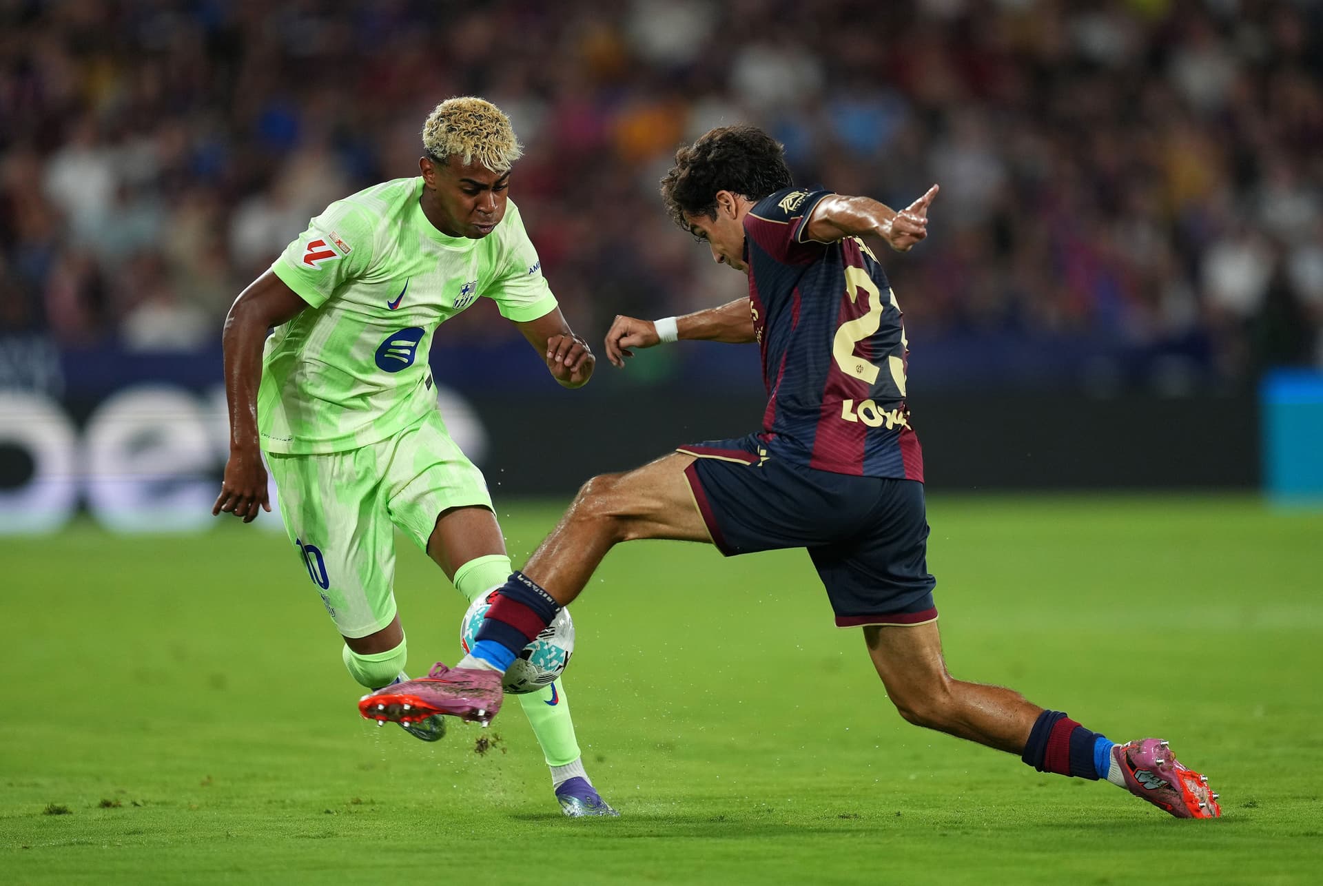 Lamine Yamal of FC Barcelona is challenged by Manuel Sanchez