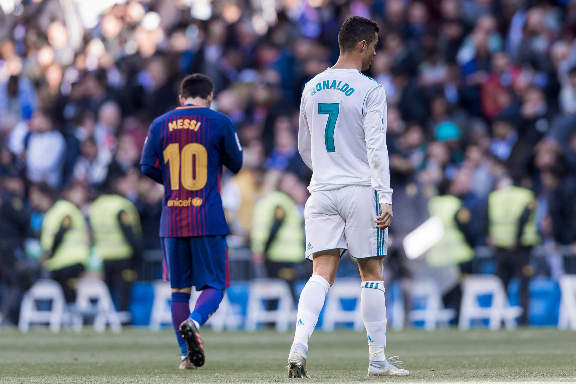 Lionel Messi of FC Barcelona and Cristiano Ronaldo of Real Madrid walk off pitch