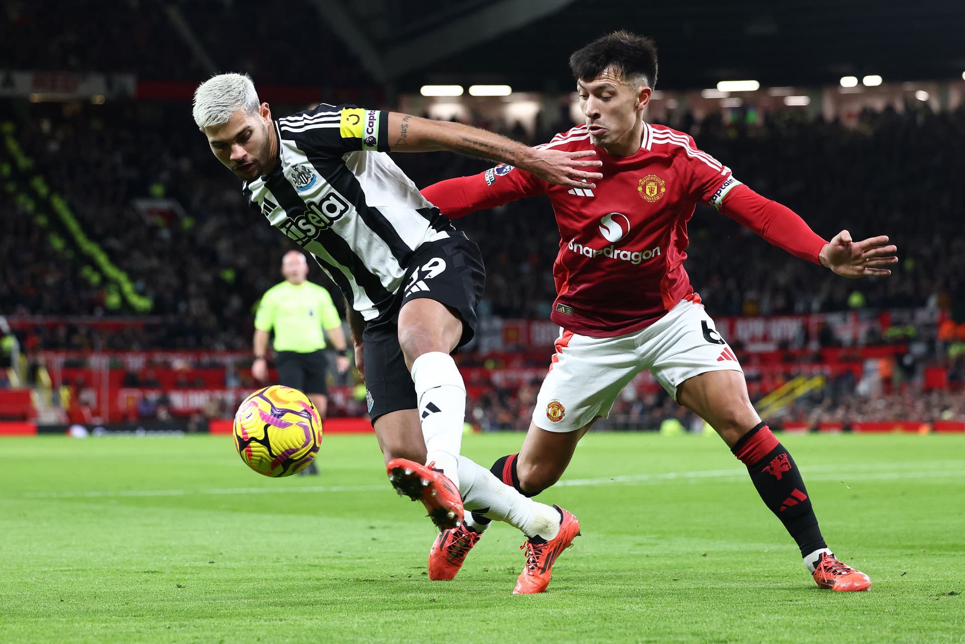 Lisandro Martinez (R) vies with Newcastle United's Brazilian midfielder #39 Bruno Guimaraes
