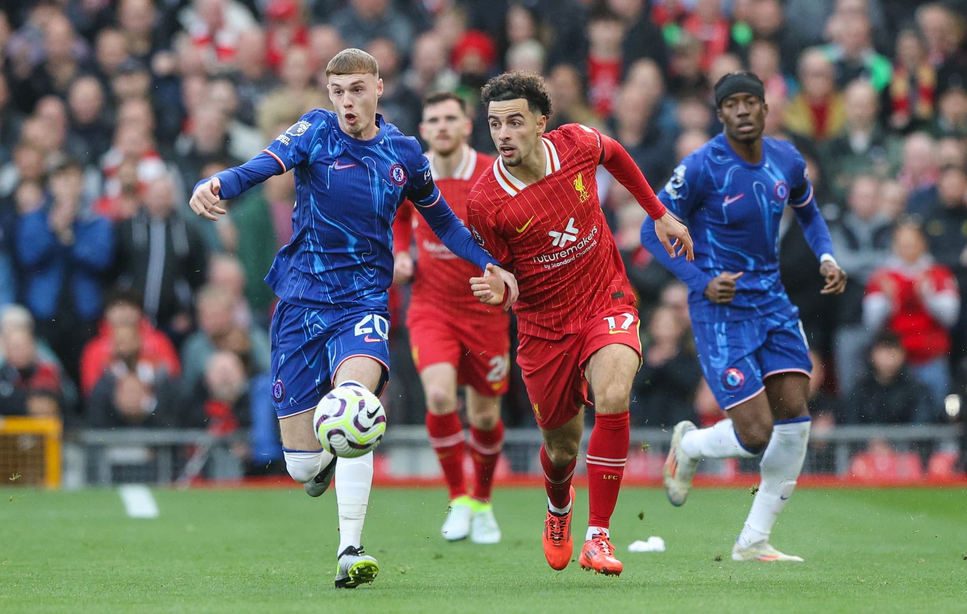 Liverpool's Curtis Jones battles with Chelsea's Cole Palmer during the Premier League match