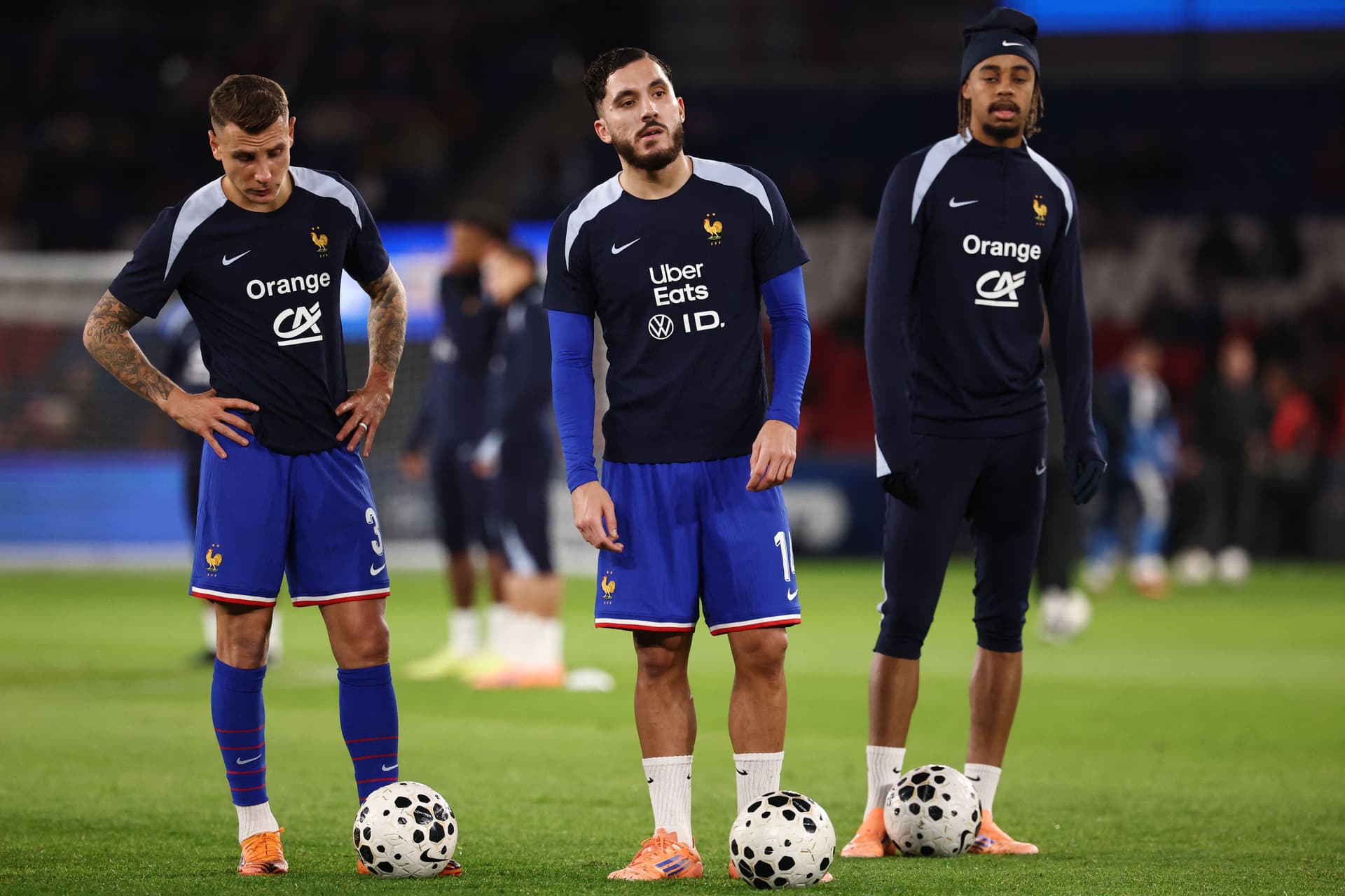 Lucas Digne, France's forward #14 Rayan Cherki and France's forward #20 Bradley Barcola warm up prior to the 2026 World Cup