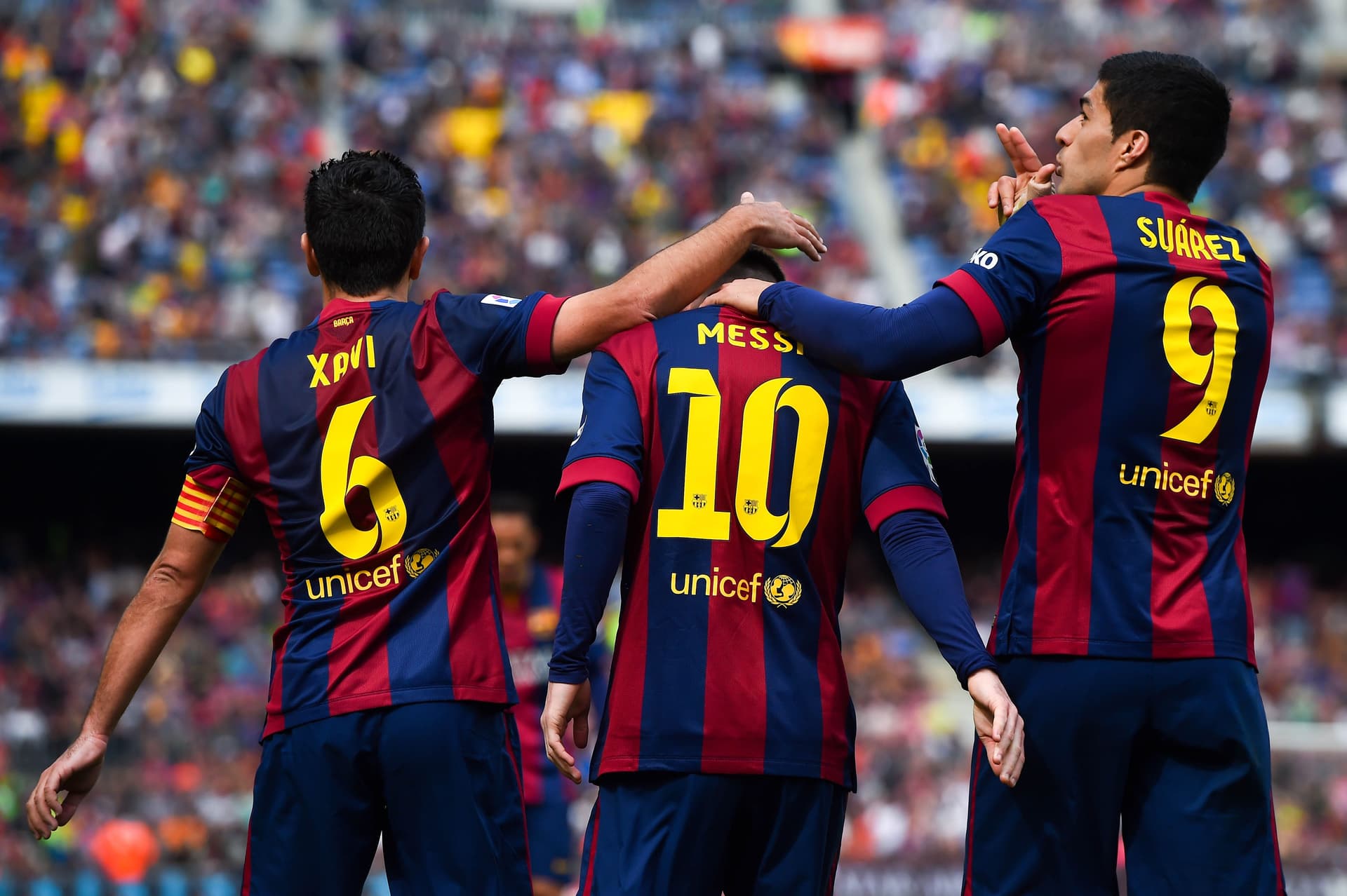 Luis Suarez of FC Barcelona with Lionel Messi and Xavi Hernandez