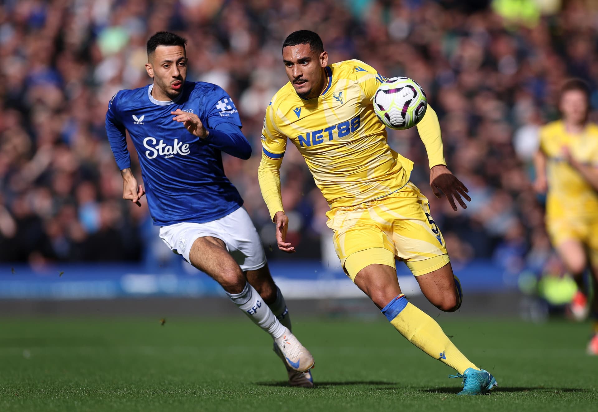 Maxence Lacroix battles for possession with Dwight McNeil