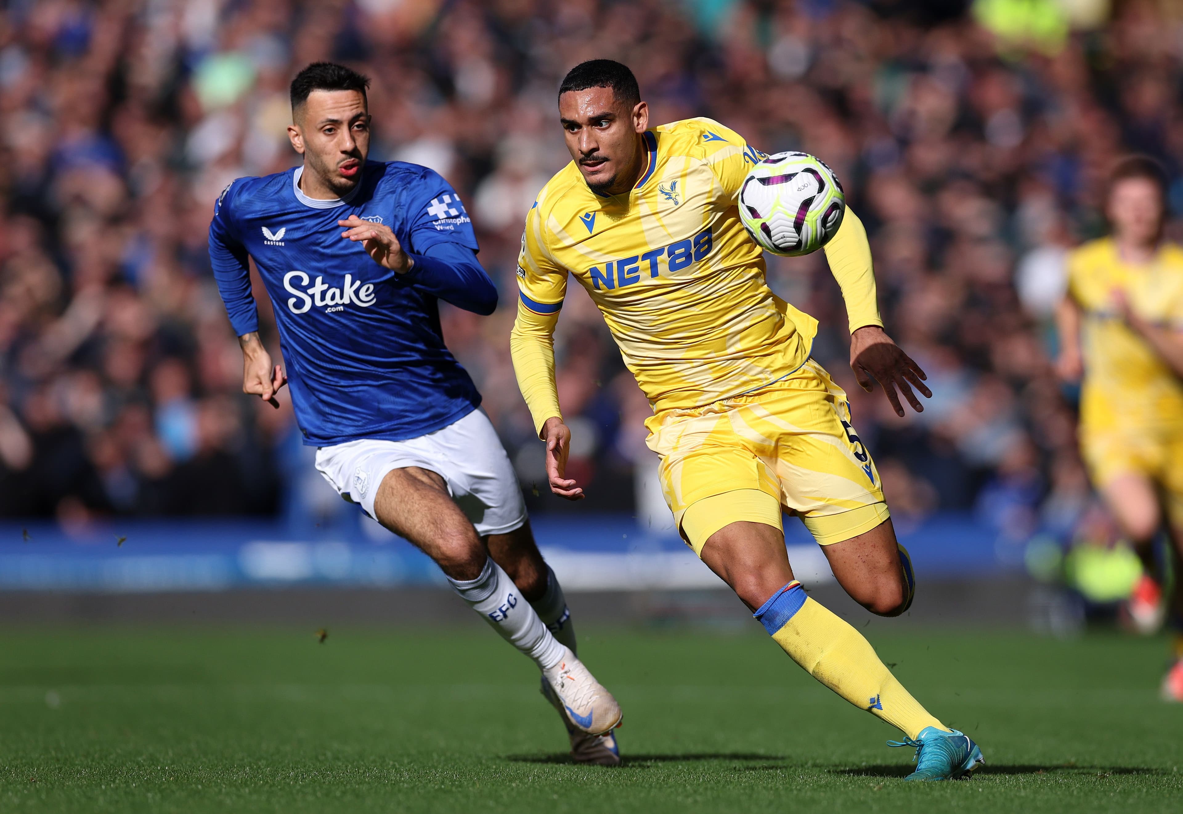 Maxence Lacroix battles for possession with Dwight McNeil