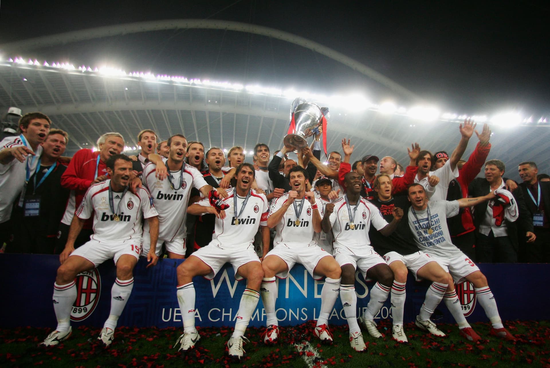Milan players celebrate with the trophy