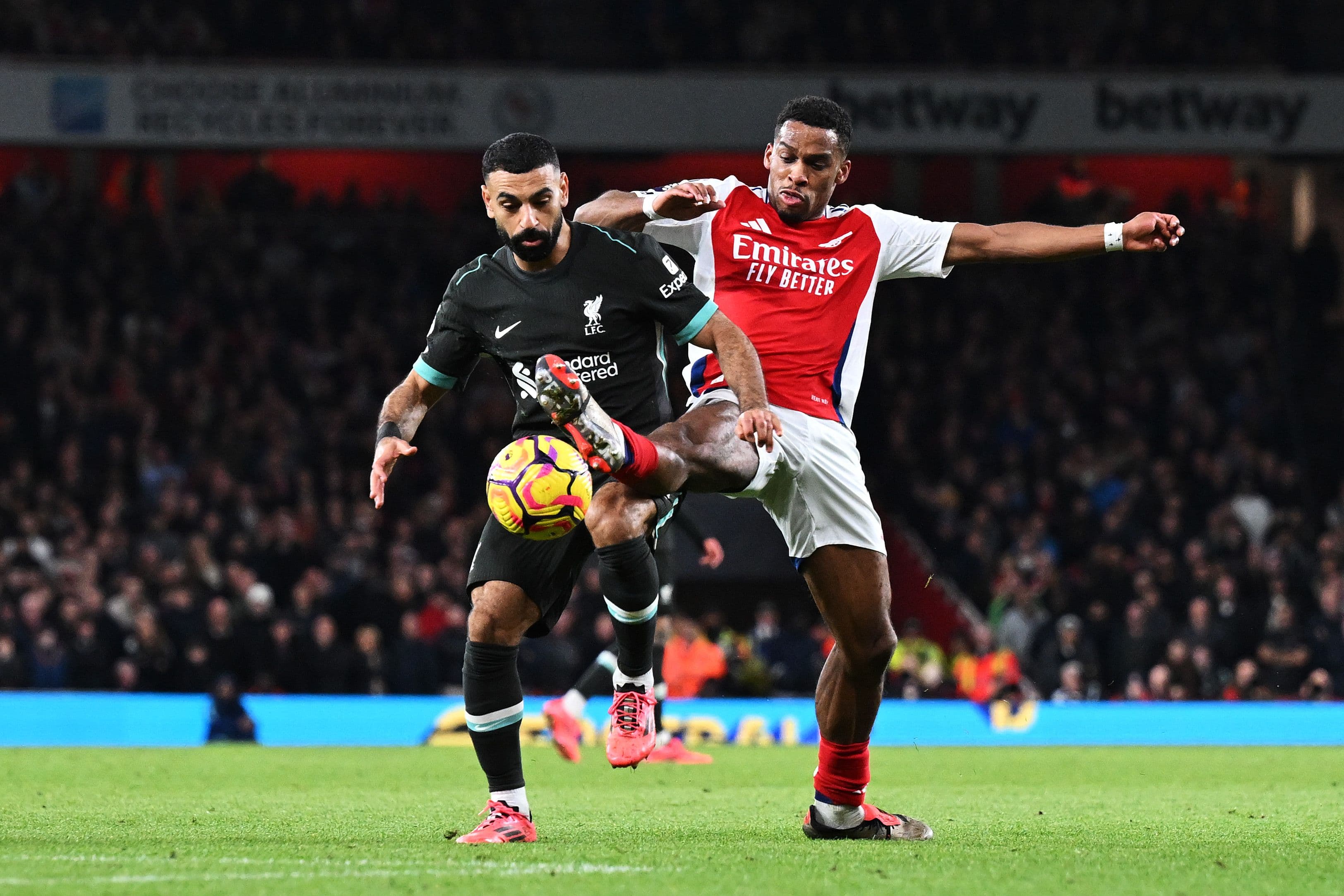 Mohamed Salah of Liverpool is challenged by Jurrien Timber of Arsenal
