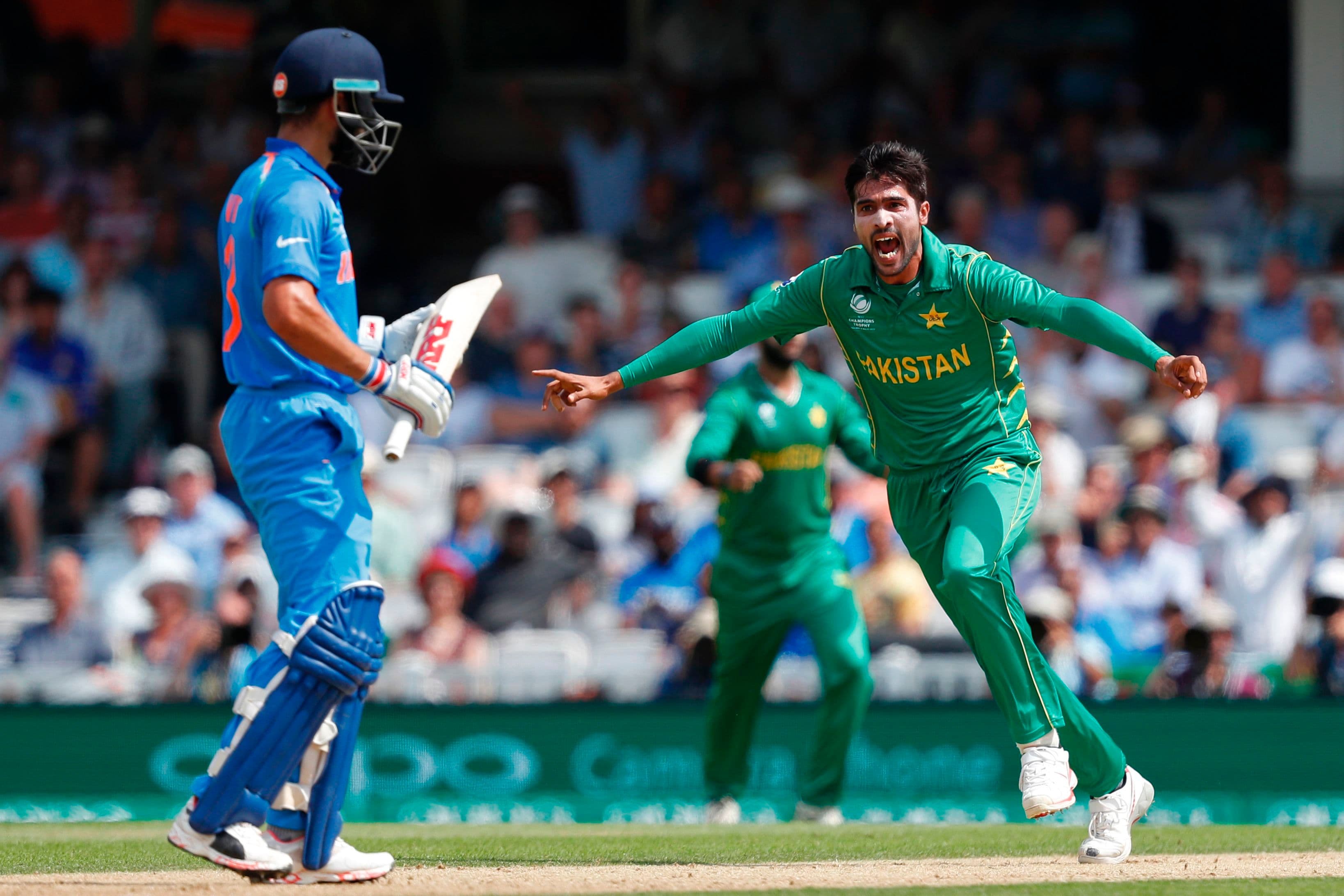 Mohammad Amir celebrates after taking the wicket of India's captain Virat Kohli