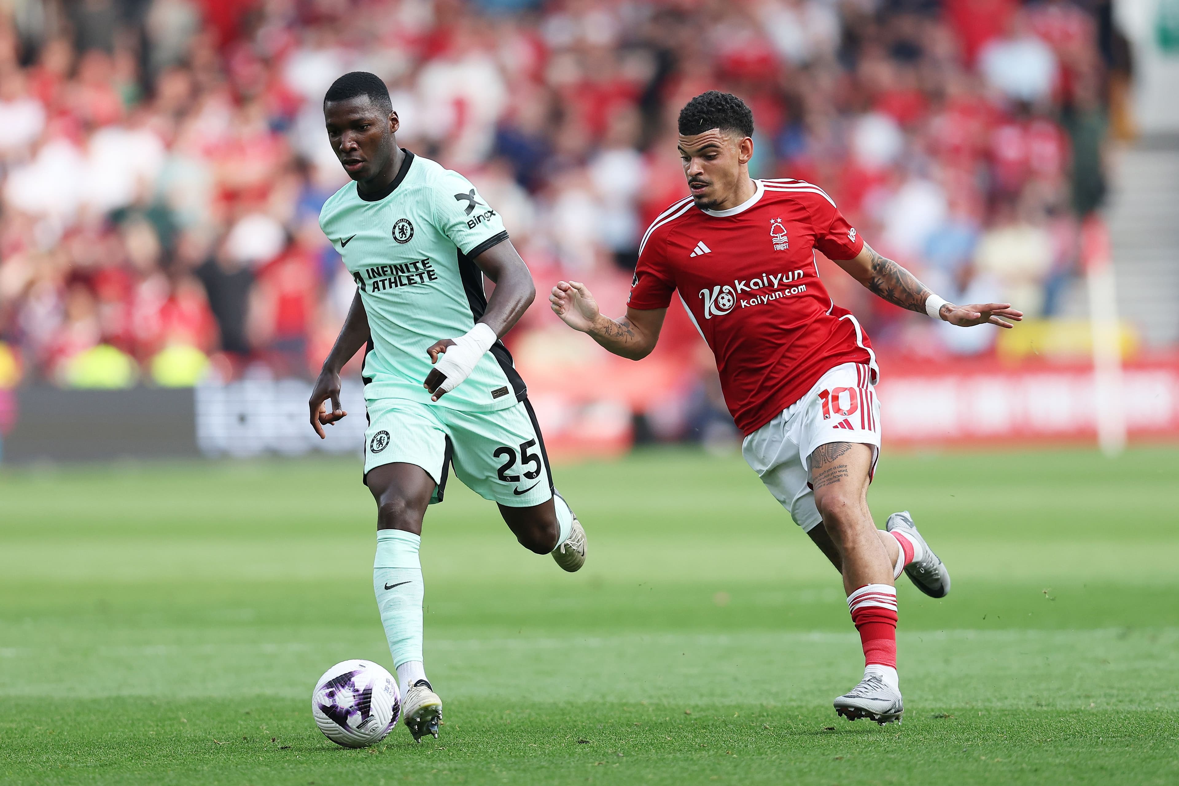 Moises Caicedo of Chelsea is challenged by Morgan Gibbs.jpg