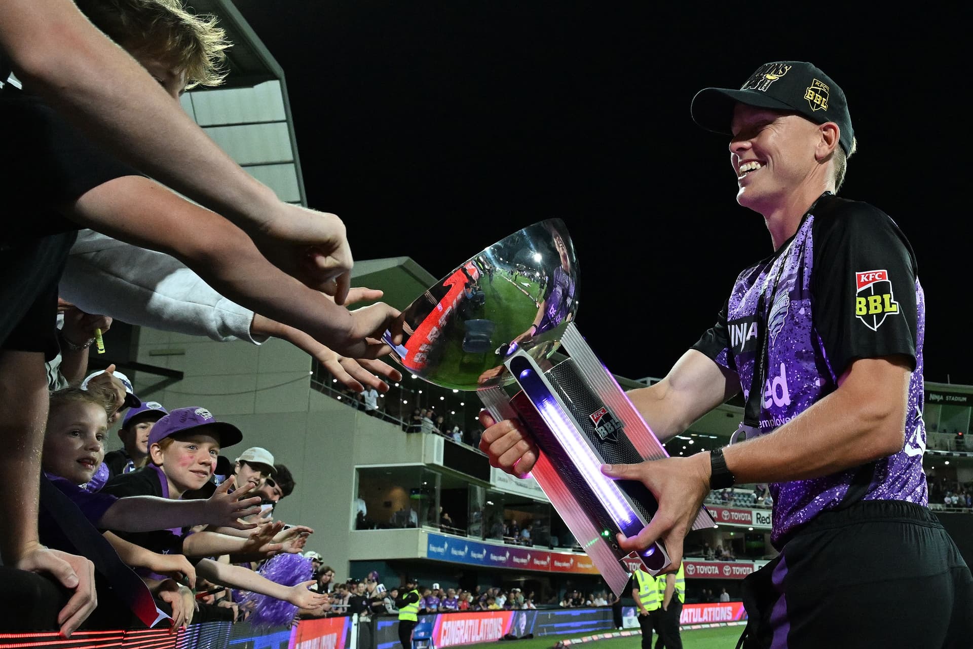 Nathan Ellis of the Hurricanes lets fans touch the BBL trophy after winning the BBL.jpg