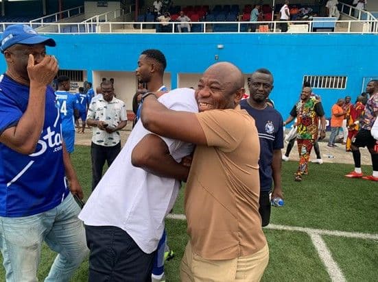 Nigerian legends Finidi George (white) and Emmanuel Amuneke (brown) embrace during an Enyimba FC fixture