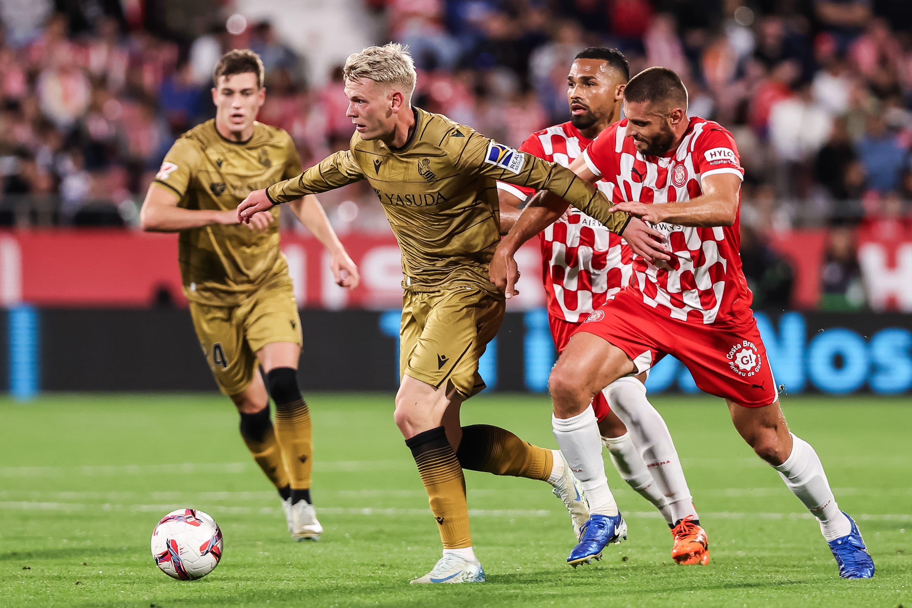 Orri Oskarsson and David Lopez compete for the ball during the Spanish league