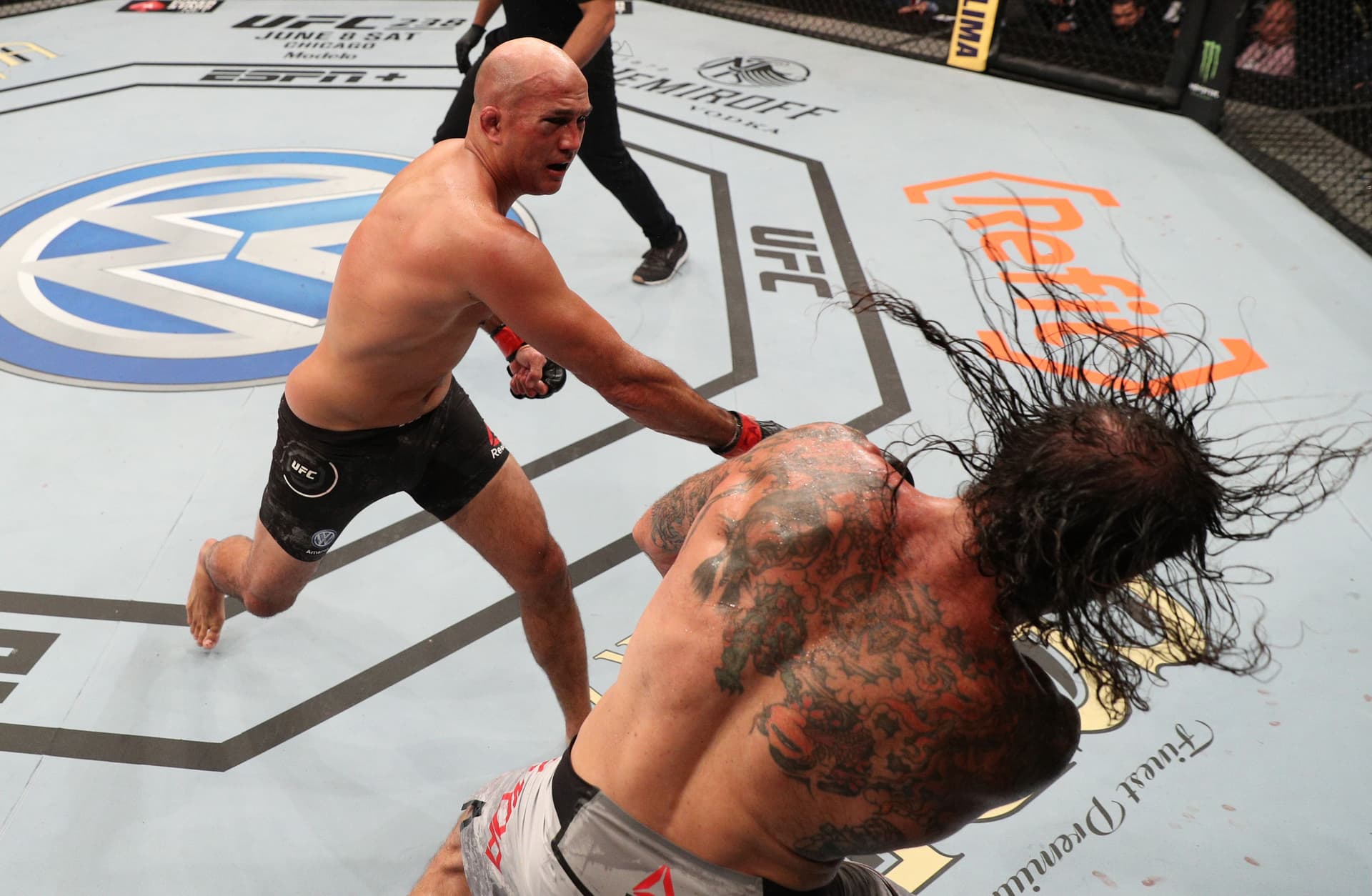 Penn punches Clay Guida in their lightweight bout during the UFC 237 event