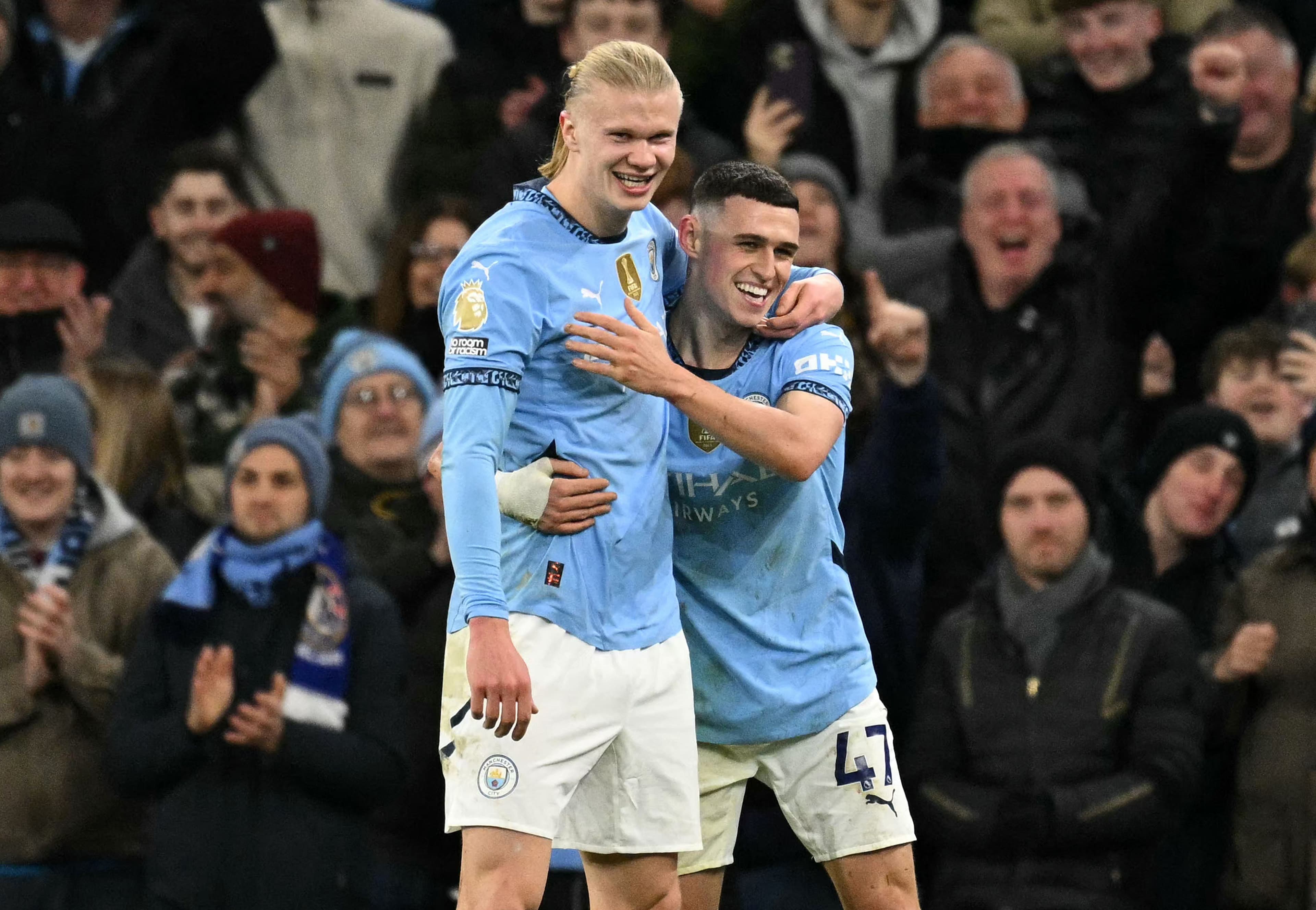 Phil Foden (R) celebrates scoring the team's third goal with Manchester City's Norwegian striker #09 Erling Haaland