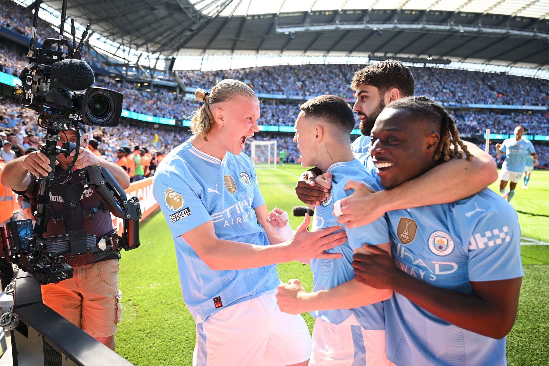 Phil Foden celebrating scoring his team's first goal with teammates