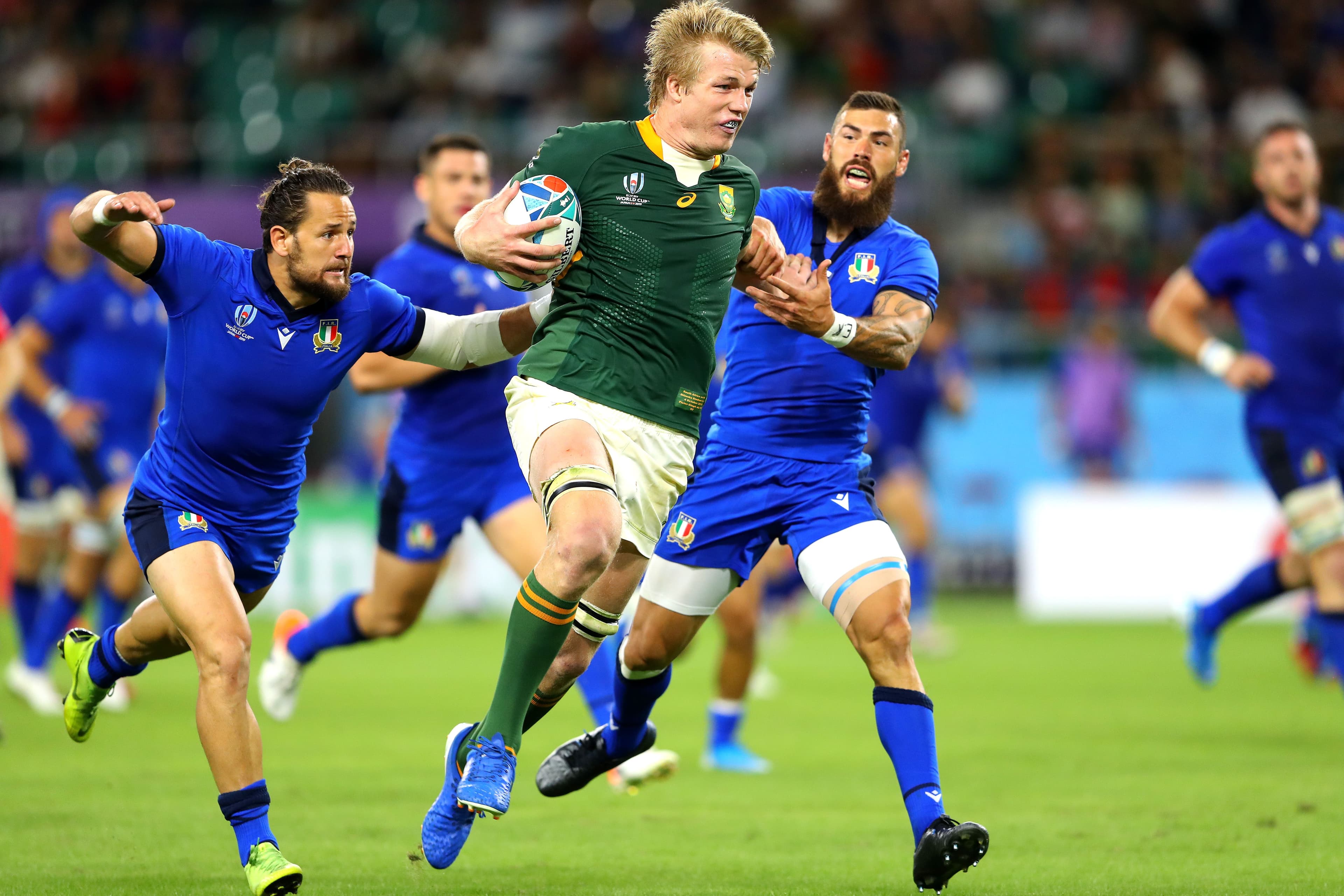 Pieter-Steph Du Toit of South Africa hands off Jayden Hayward of Italy