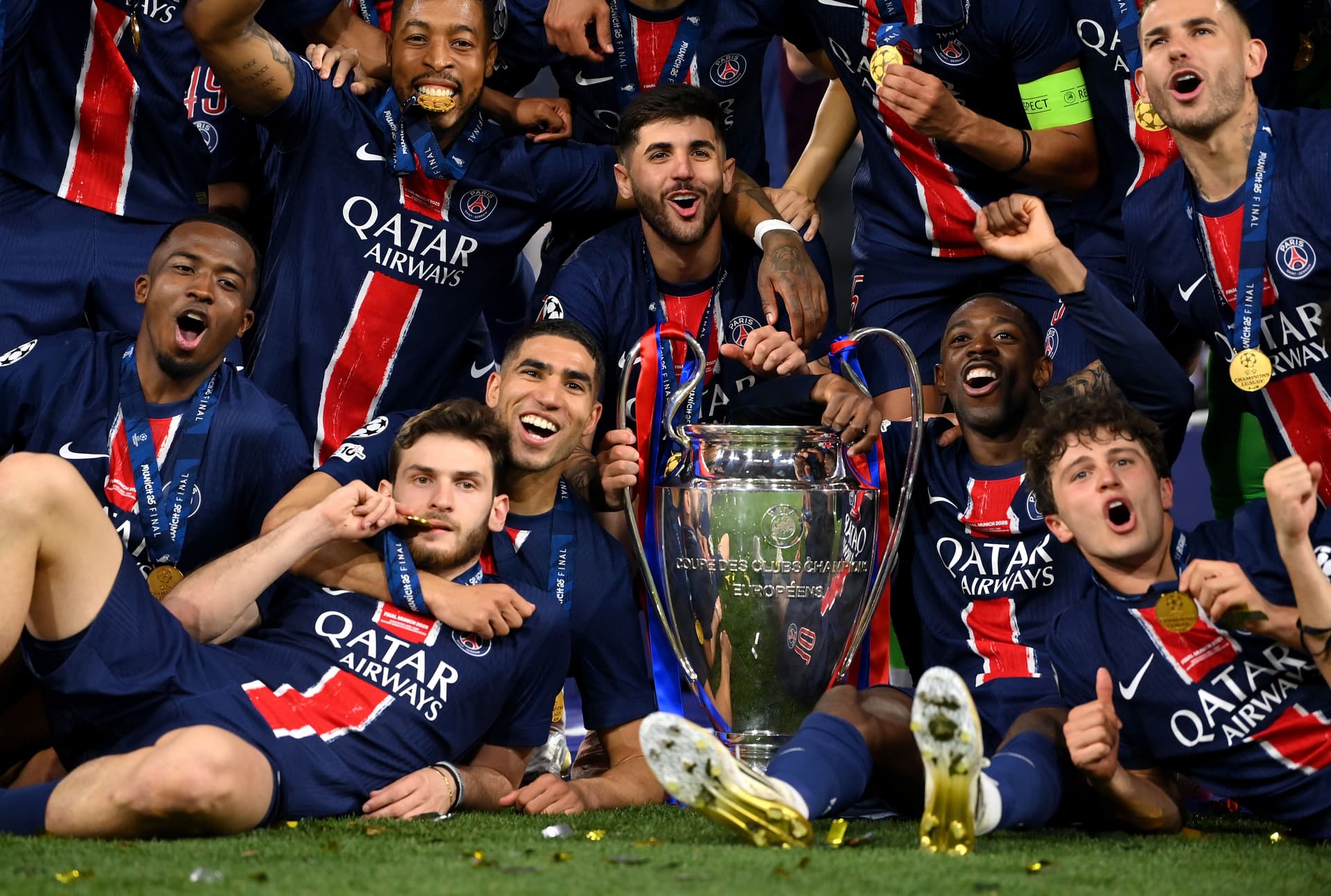 Players of Paris Saint-Germain celebrate with the UEFA Champions League trophy