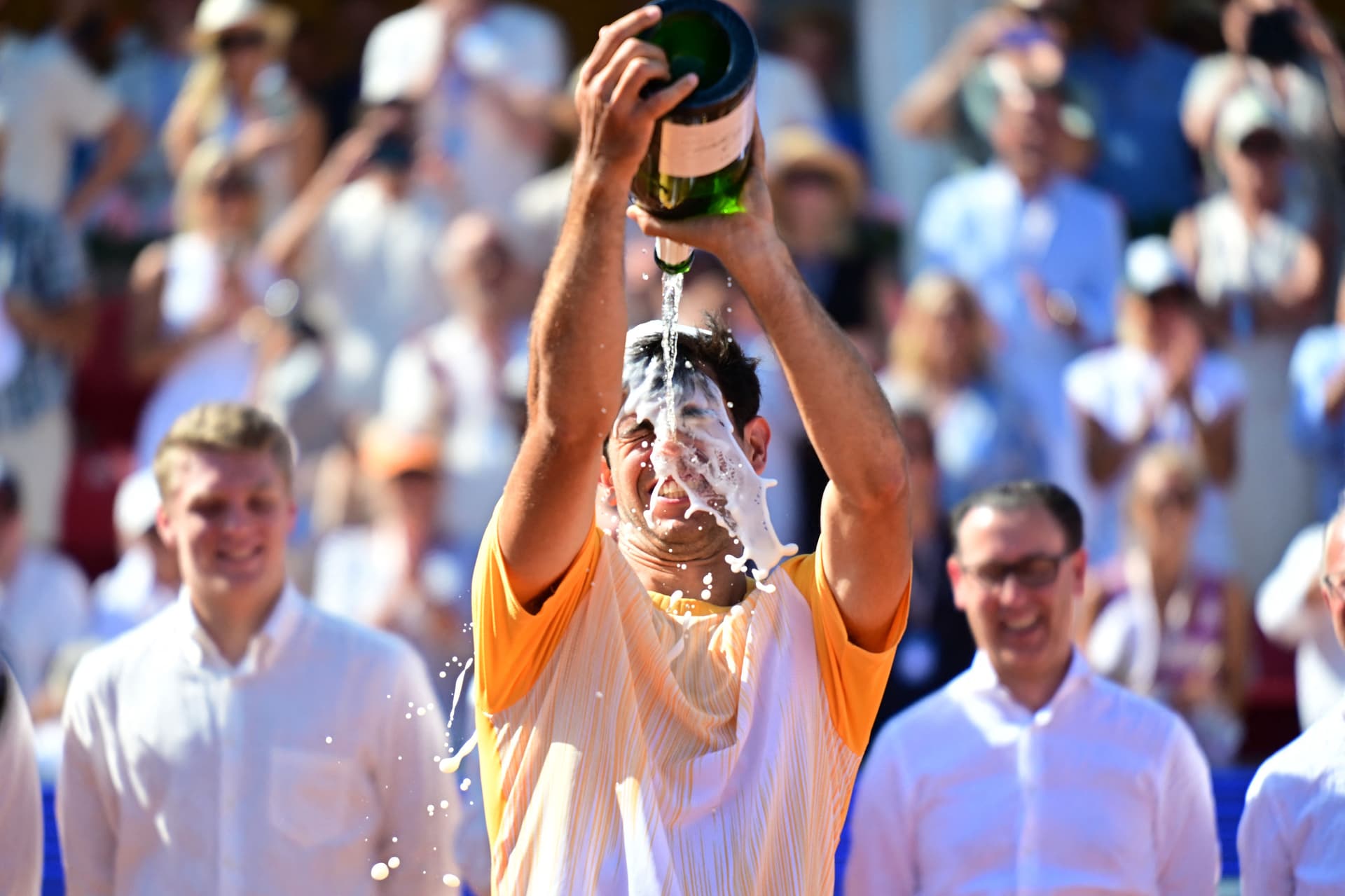 Portugal's Nuno Borges celebrates with Champagne after winning over Spain's Rafael Nadal