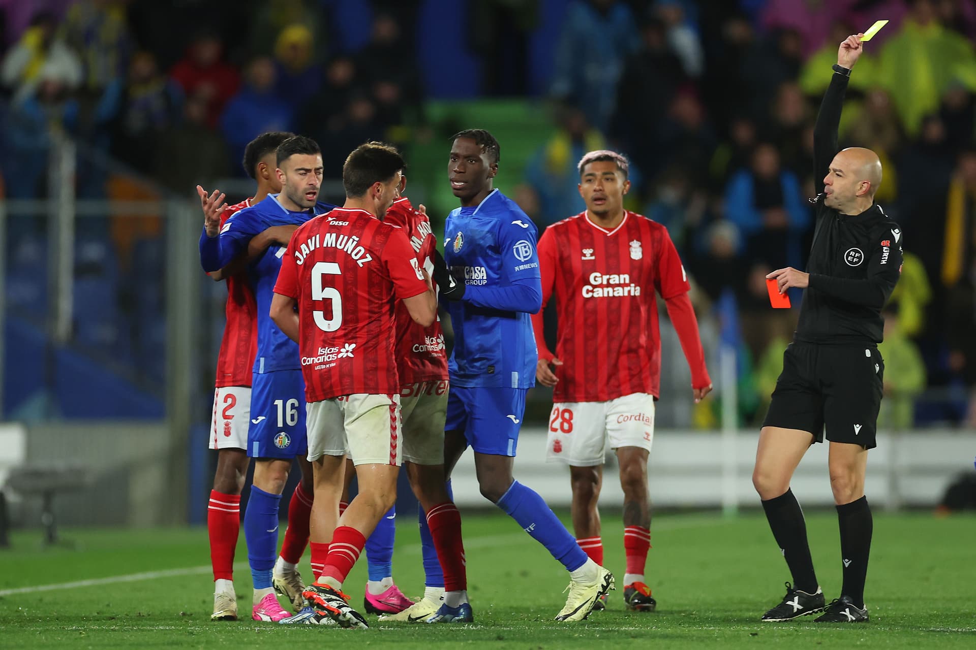 Referee Pablo Gonzales Fuertes gives Javi Munoz of UD Las Palmas a yellow card