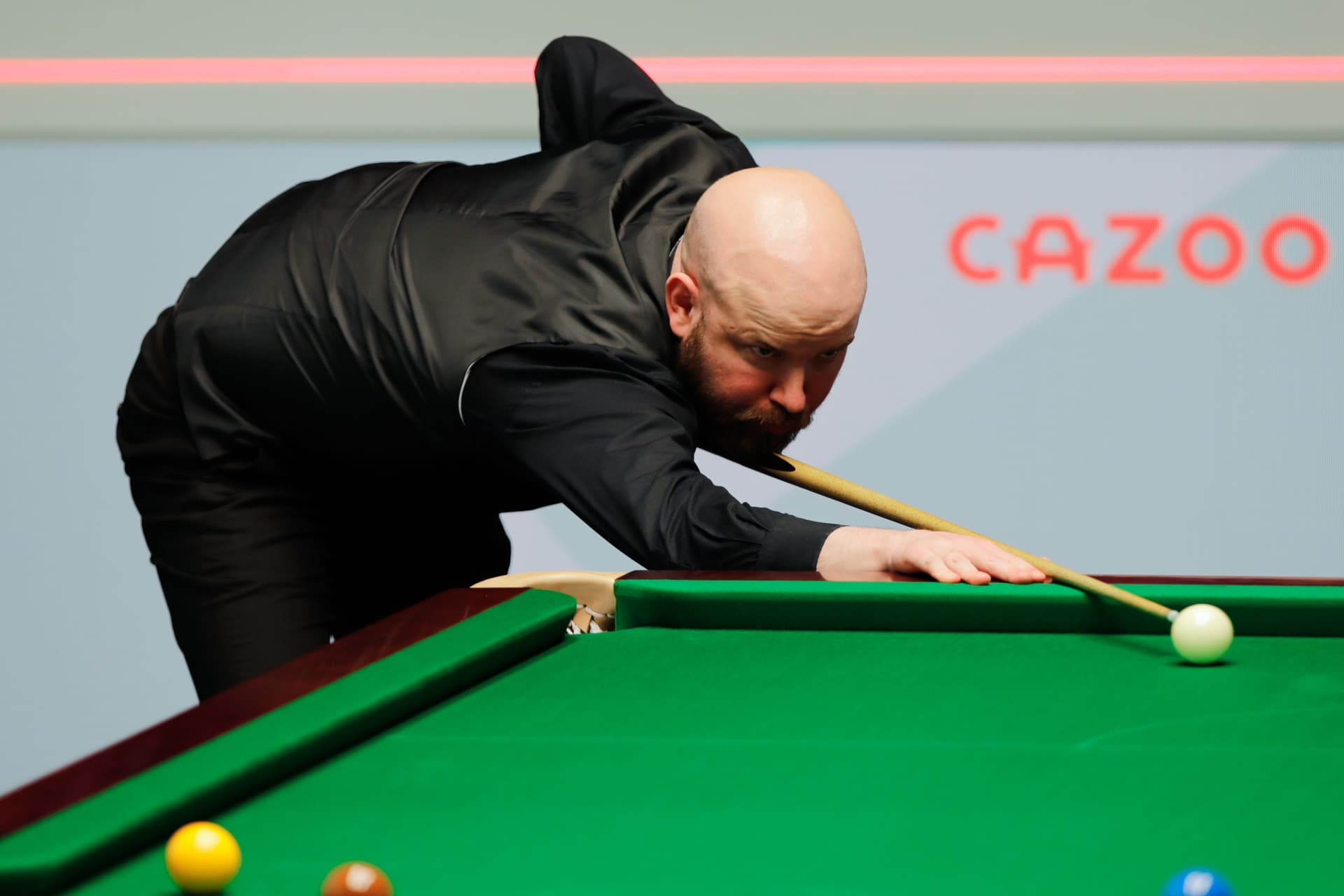 Robbie Williams of England plays a shot in the first round match against Mark Allen