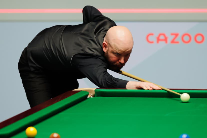 Robbie Williams of England plays a shot in the first round match against Mark Allen