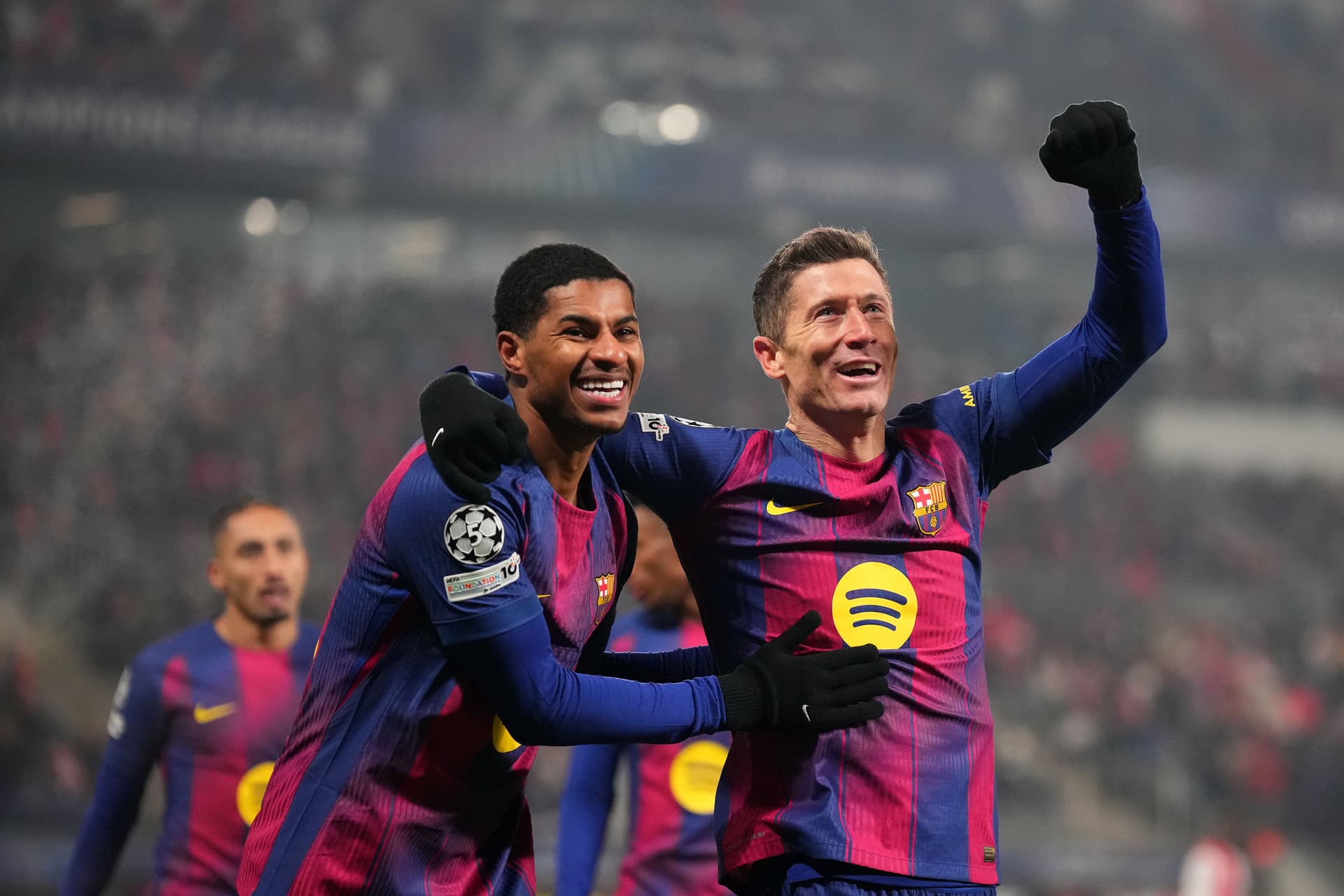 Robert Lewandowski of FC Barcelona celebrates scoring his team's fourth goal with teammate