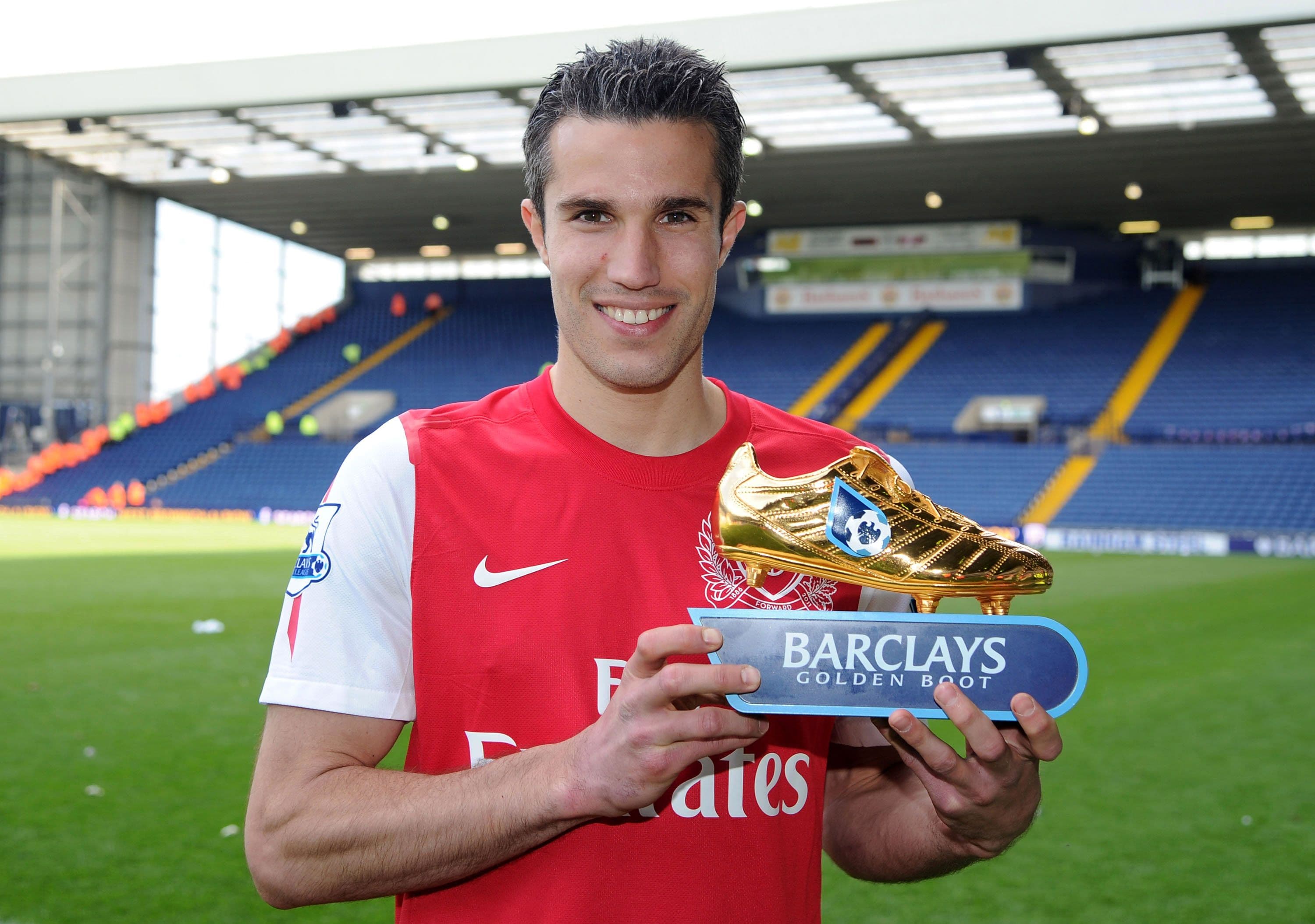 Robin van Persie of Arsenal poses with the golden boot