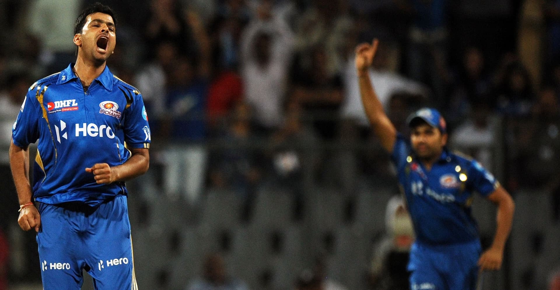 Rudra Pratap Singh (L) reacts as teammate Rohit Sharma celebrates after the dismissal of unseen Kolkata Knight Riders.jpg