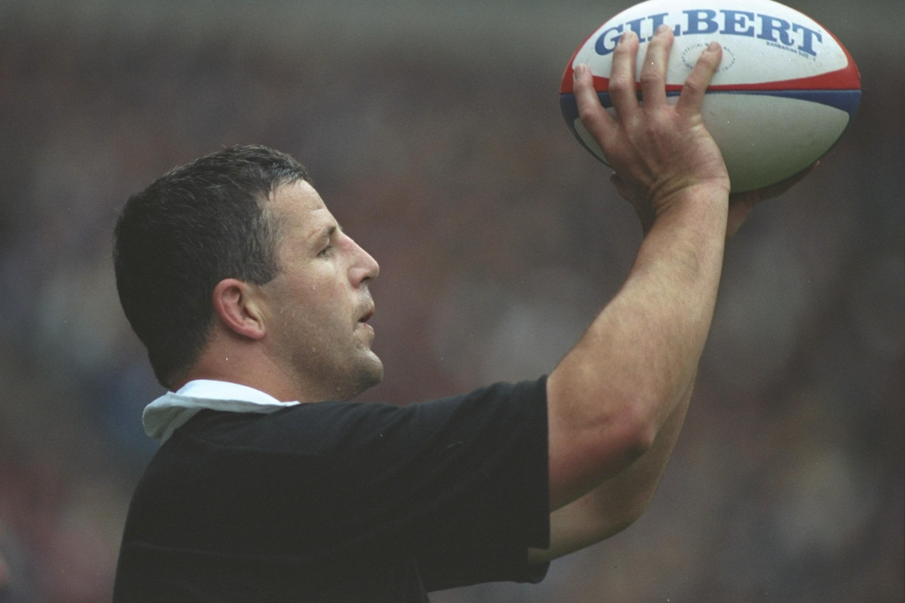 Sean Fitzpatrick of New Zealand prepares the pass in for the line-out