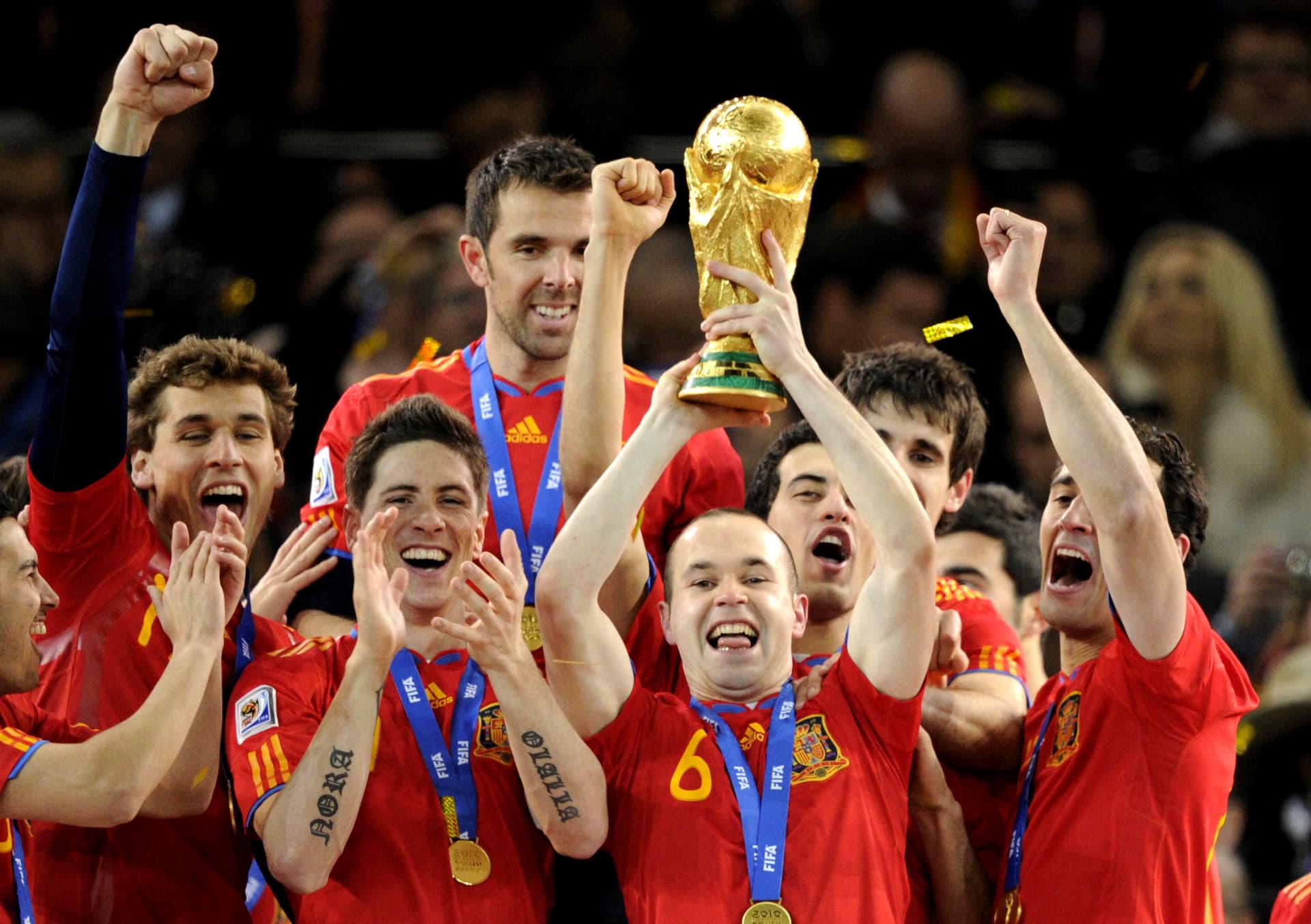 Spain's midfielder Andres Iniesta raises the trophy
