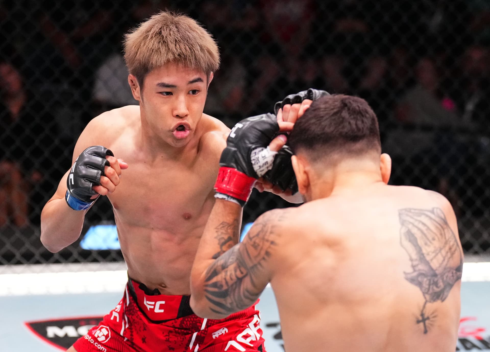 Tatsuro Taira of Japan punches Alex Perez in a flyweight