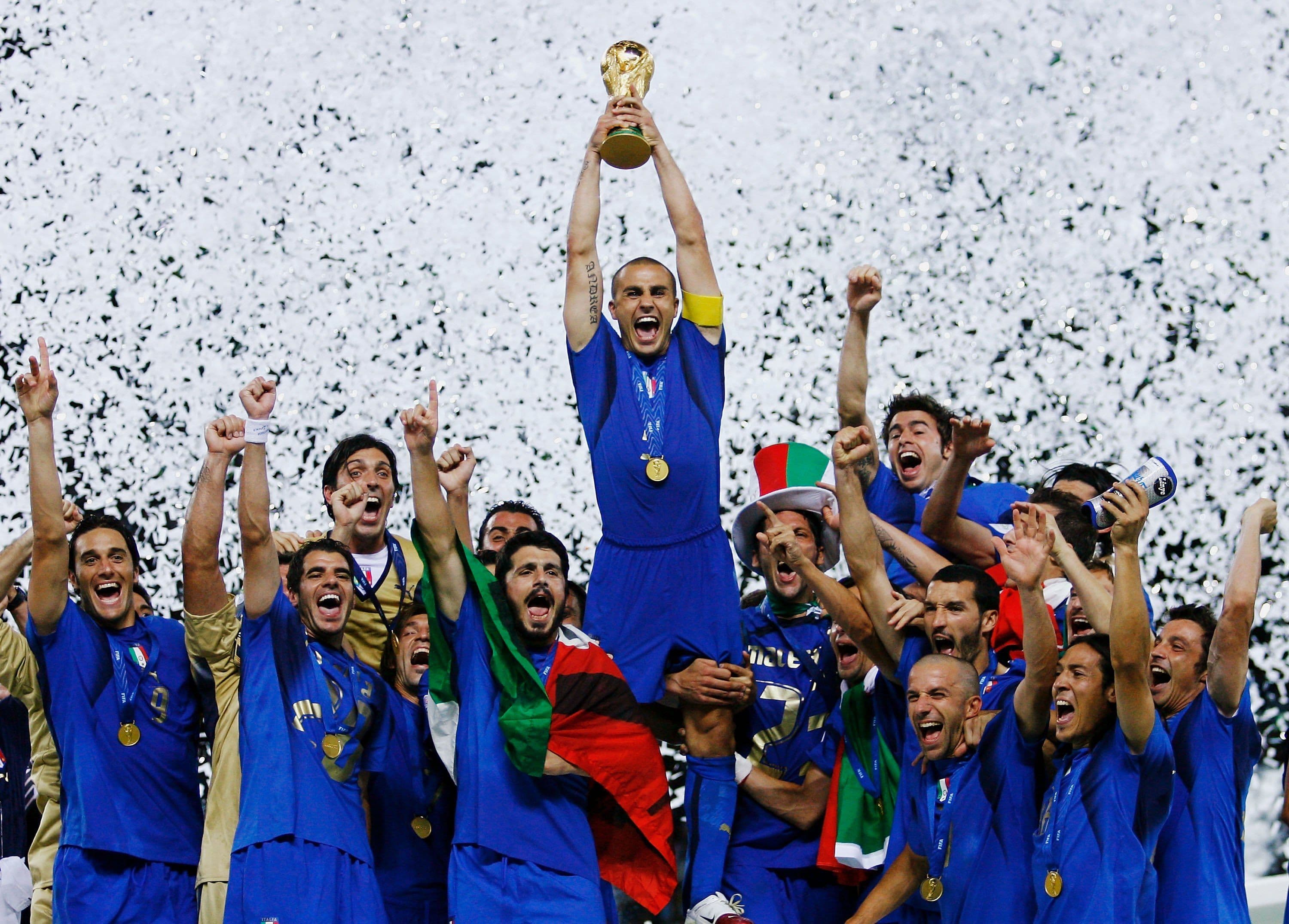 The Italian players celebrate as Fabio Cannavaro of Italy lifts the World Cup trophy