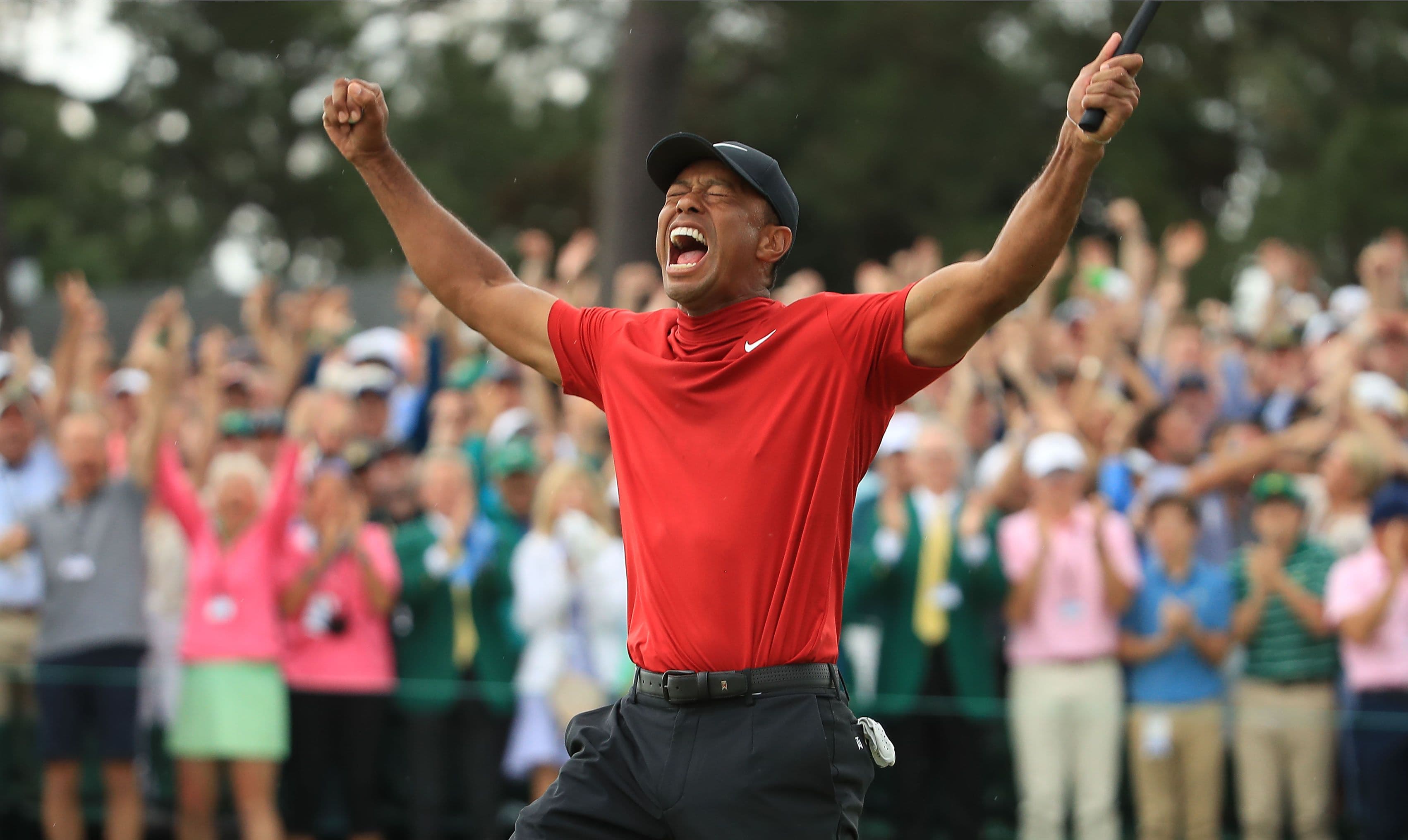 Tiger Woods of the United States celebrates on the 18th green after winning the Masters at Augusta National Golf Club