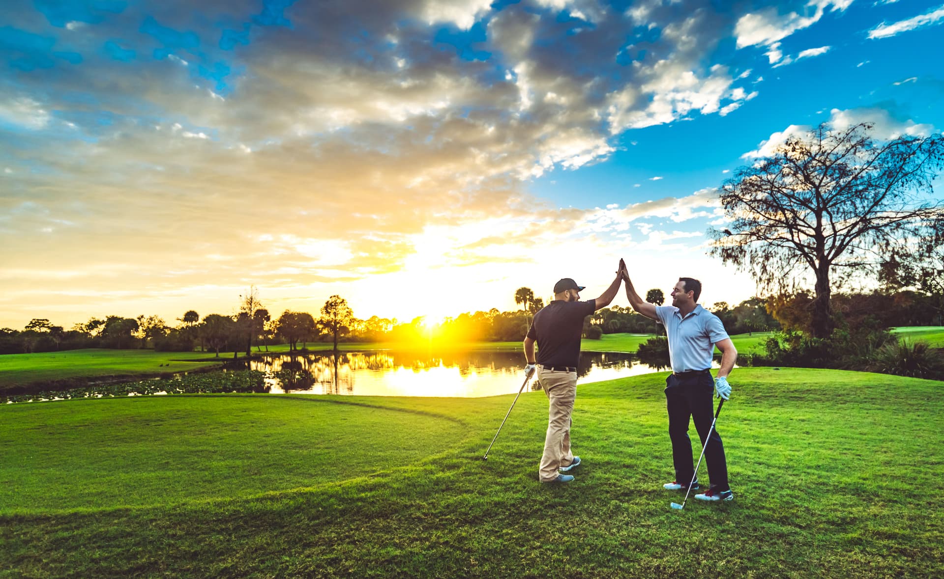 Two male golfers high five